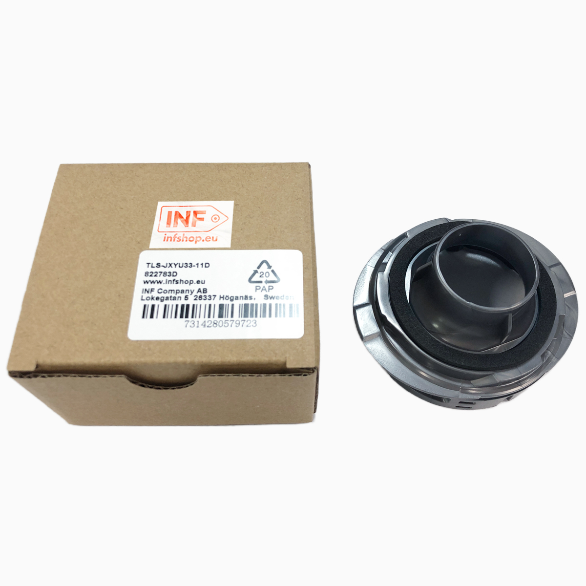 Kartonowe pudełko z etykietą i czarna plastikowa część o okrągłym kształcie. Pudełko po lewej, część po prawej.