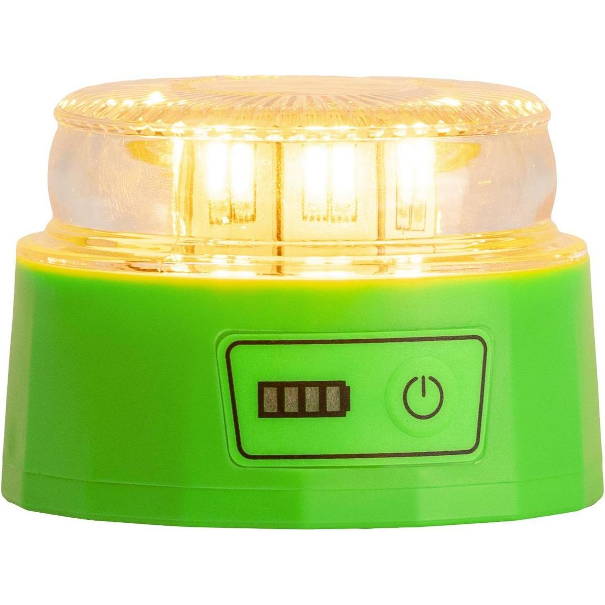 Un dispositivo verde con una parte superior transparente e iluminada en amarillo. Tiene un símbolo de batería y botón de encendido. La parte superior es una cúpula transparente.