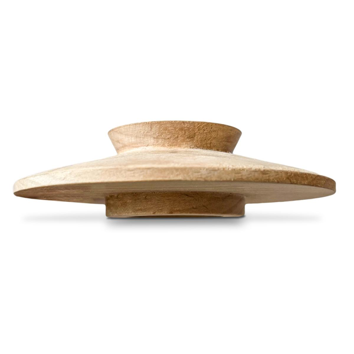 A wooden, mushroom-shaped object with a wide, flat base and a smaller, rounded top, against a white background.
