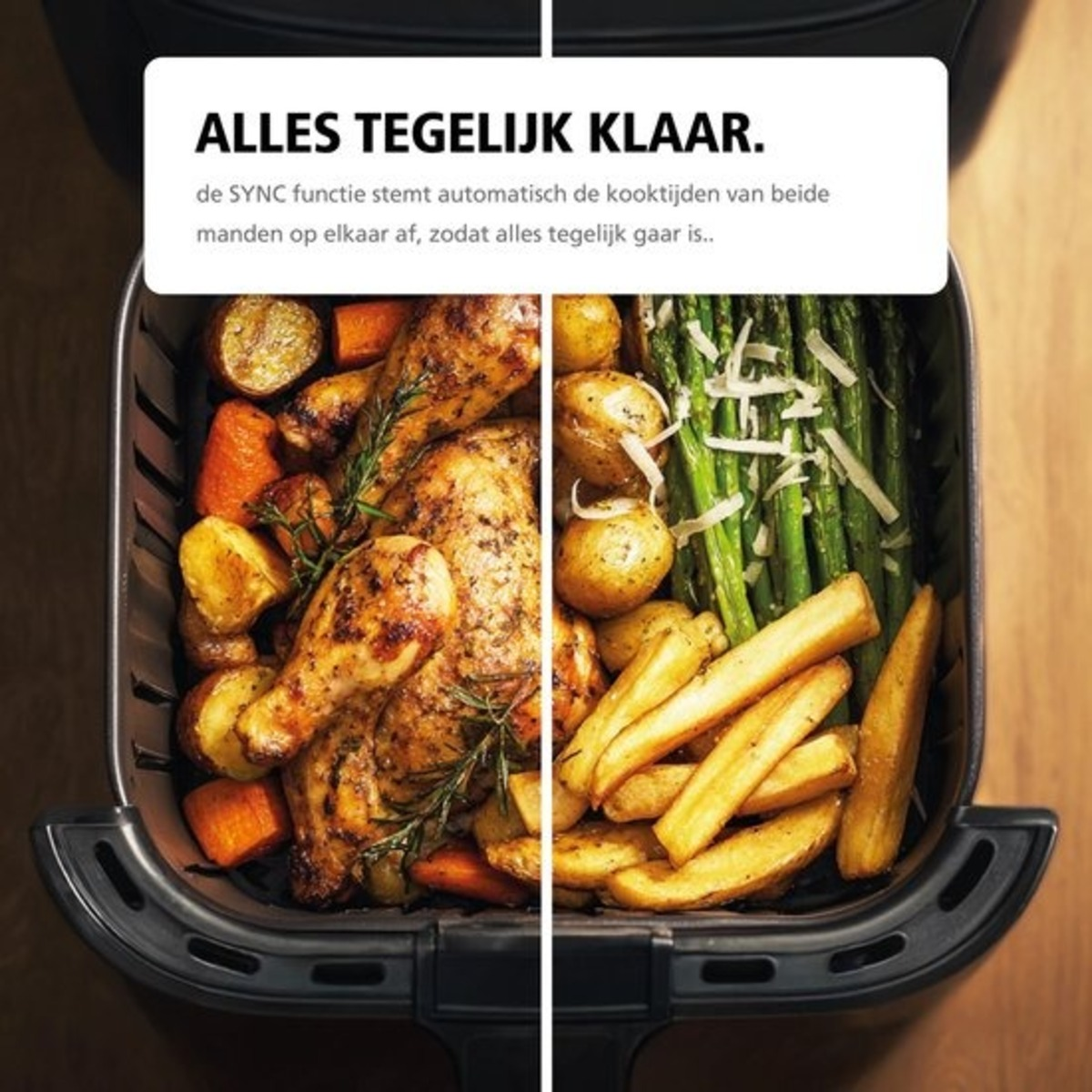 Een airfryer met gebraden kip, aardappelen, wortelen, asperges en pastinaak. De tekst op de achtergrond luidt 'Alles tegelijk klaar'.