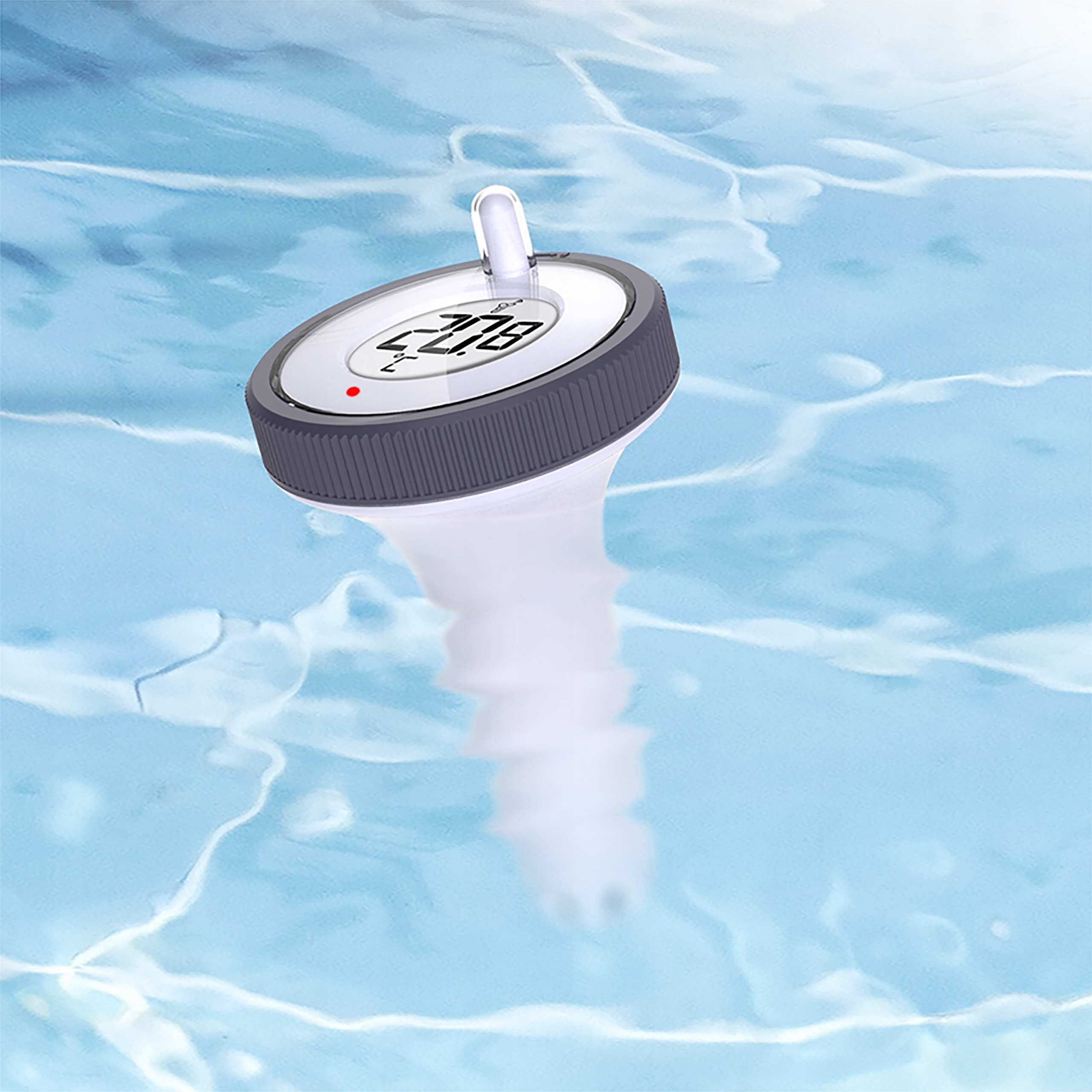 Termometr basenowy unosi się w wodzie. Wyświetlacz pokazuje 20,8. Woda jest jasnoniebieska i ma pofalowane odbicia.