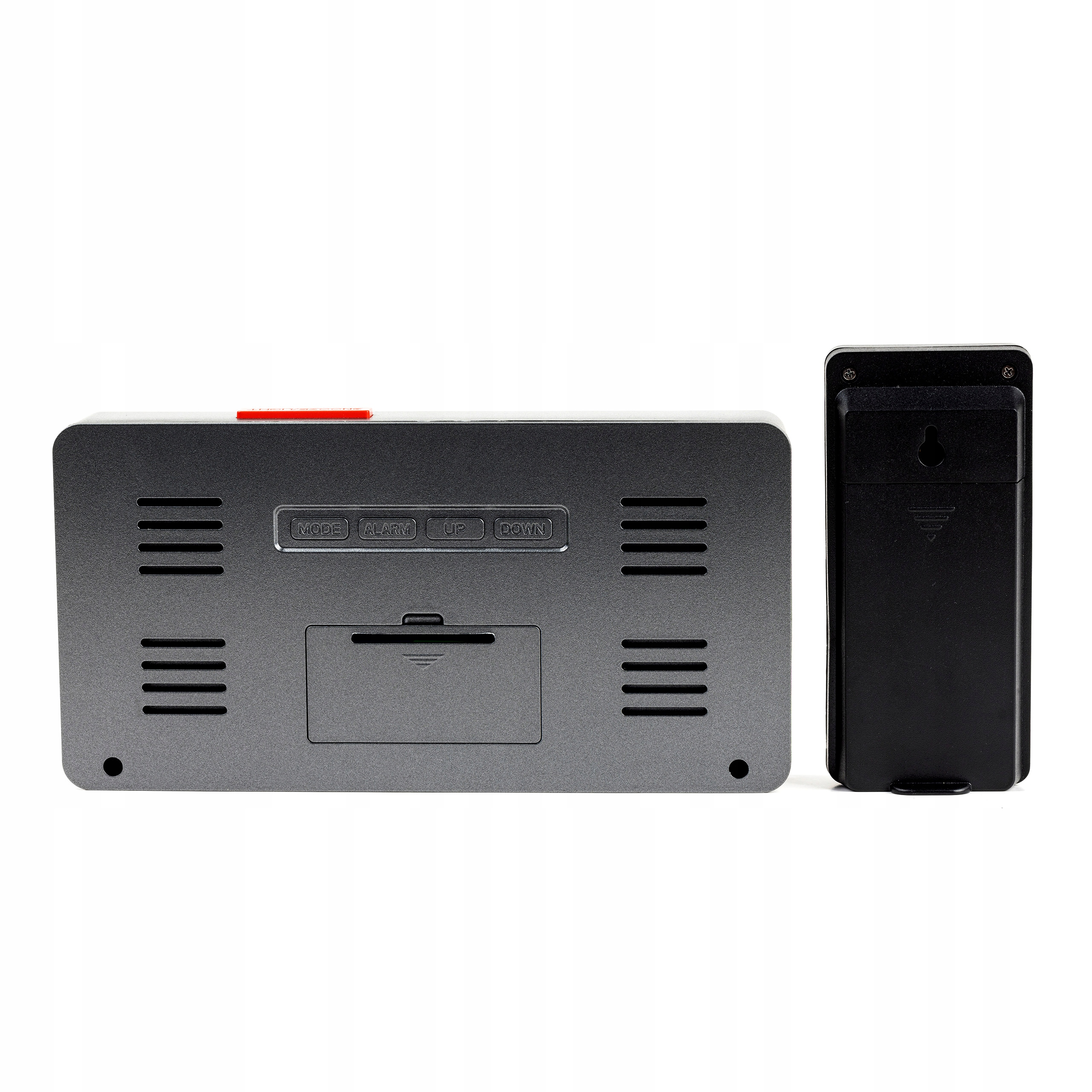 Zegar cyfrowy z czarnym prostokątnym wyświetlaczem i oddzielnym czarnym modułem na białej powierzchni.