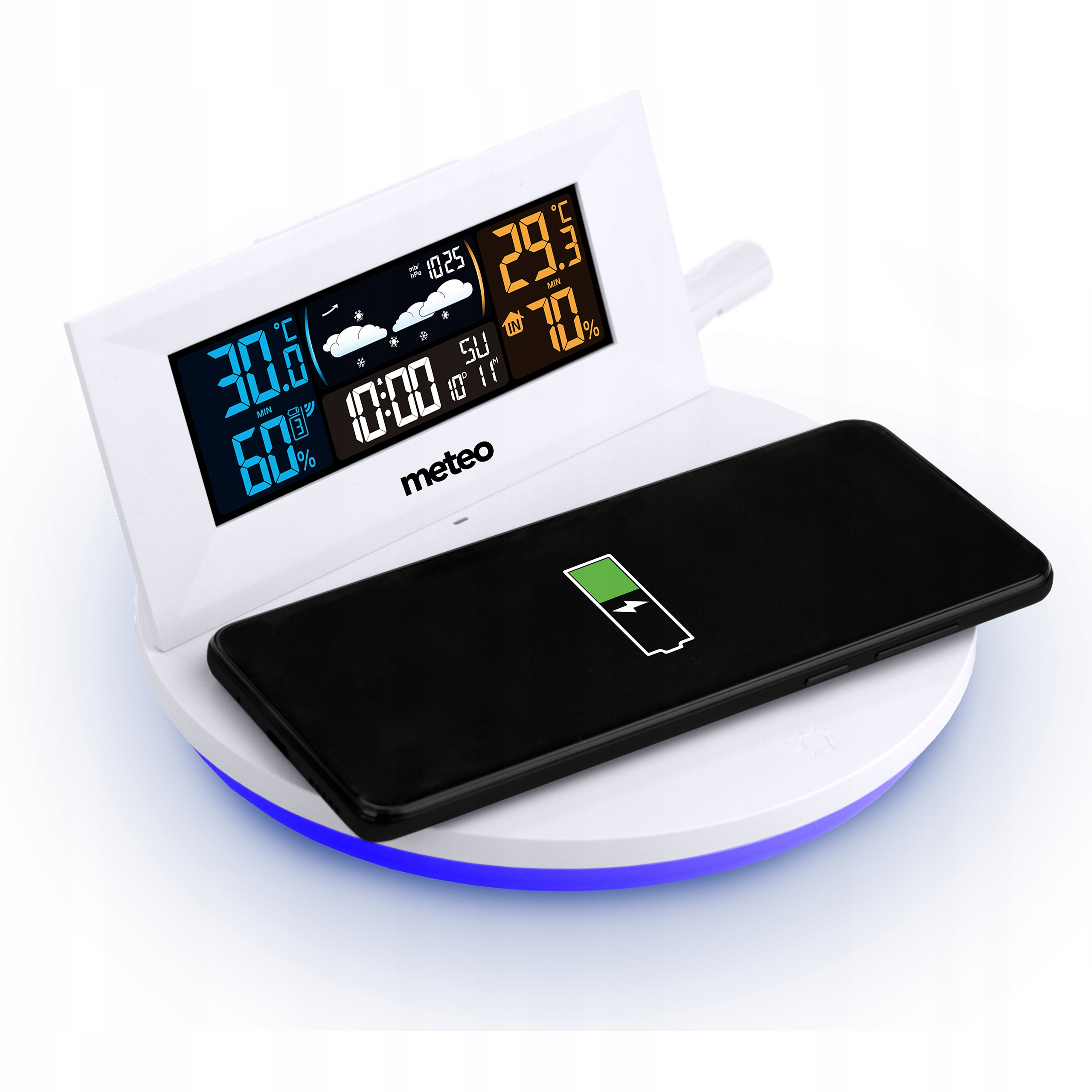 Biała cyfrowa stacja pogodowa wyświetla temperaturę i wilgotność. Czarny telefon spoczywa na podstawie ładującej.