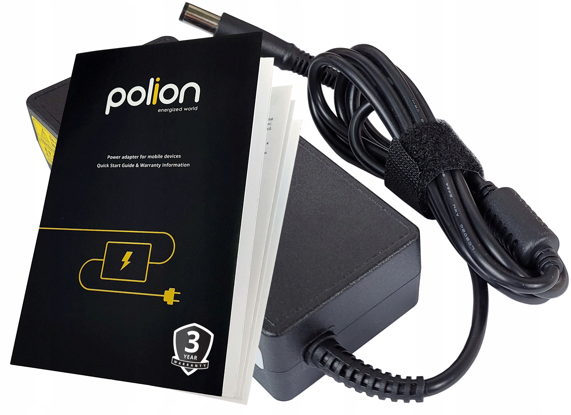 Czarny zasilacz i kabel z książką z przodu, pokazujący nazwę marki i informacje o gwarancji.