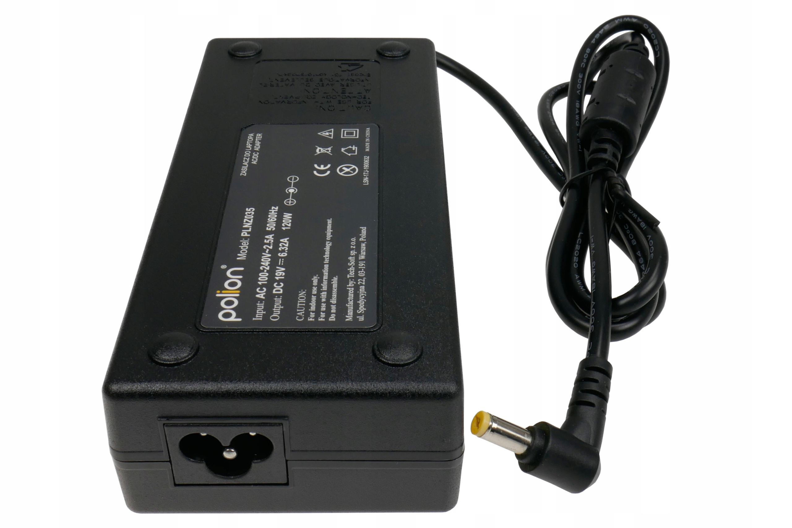 Czarny zasilacz do laptopa z czarnym kablem i żółtą końcówką na białej powierzchni.