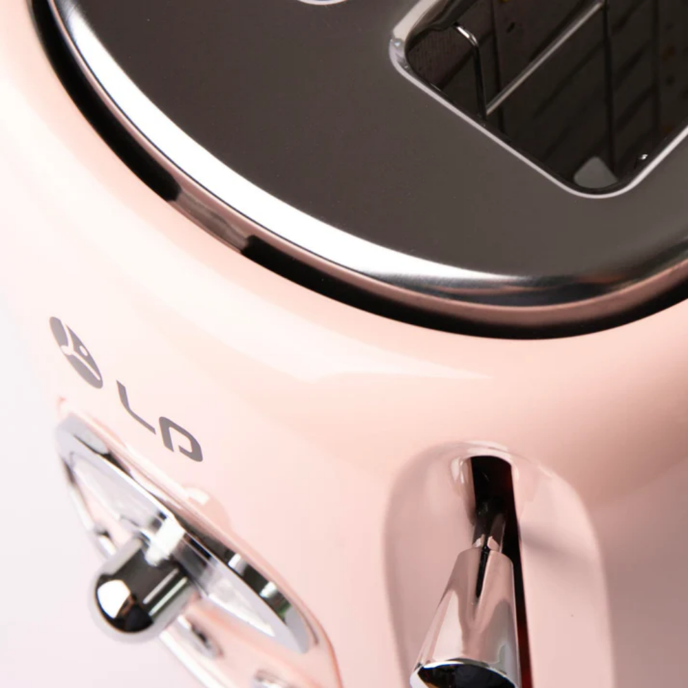 Nahaufnahme eines rosa Toasters mit Chromakzenten. Der Toaster hat ein Logo, einen Hebel und ein Zifferblatt.