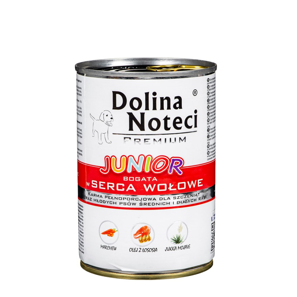 Puszka karmy dla psów z napisem 'Dolina Noteci Junior'. Zawiera zdjęcia szczeniaka, marchewki, oleju z łososia i jukki. Białe tło.