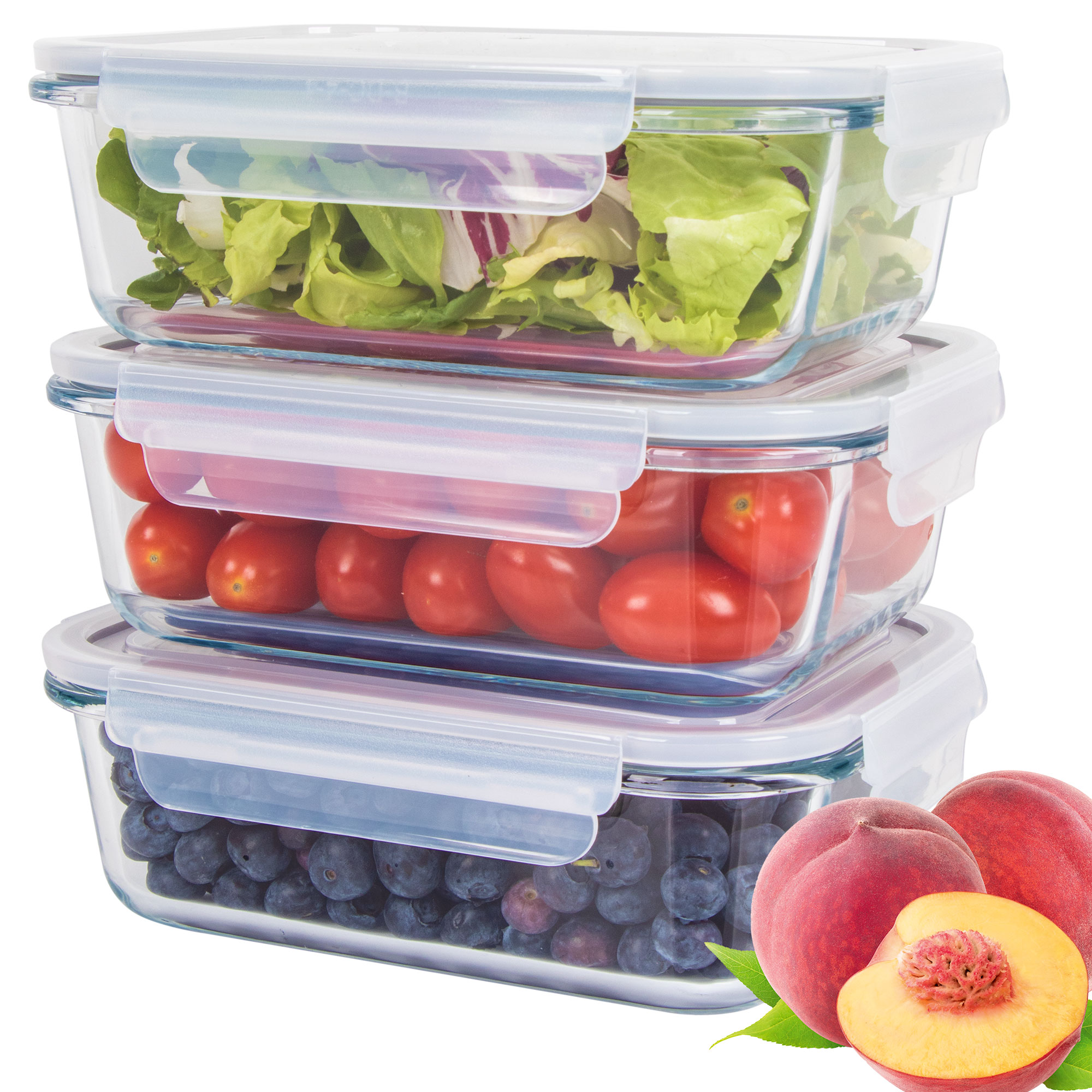 Trzy szklane pojemniki ułożone w stos z sałatą, pomidorami i jagodami. Brzoskwinie po prawej.