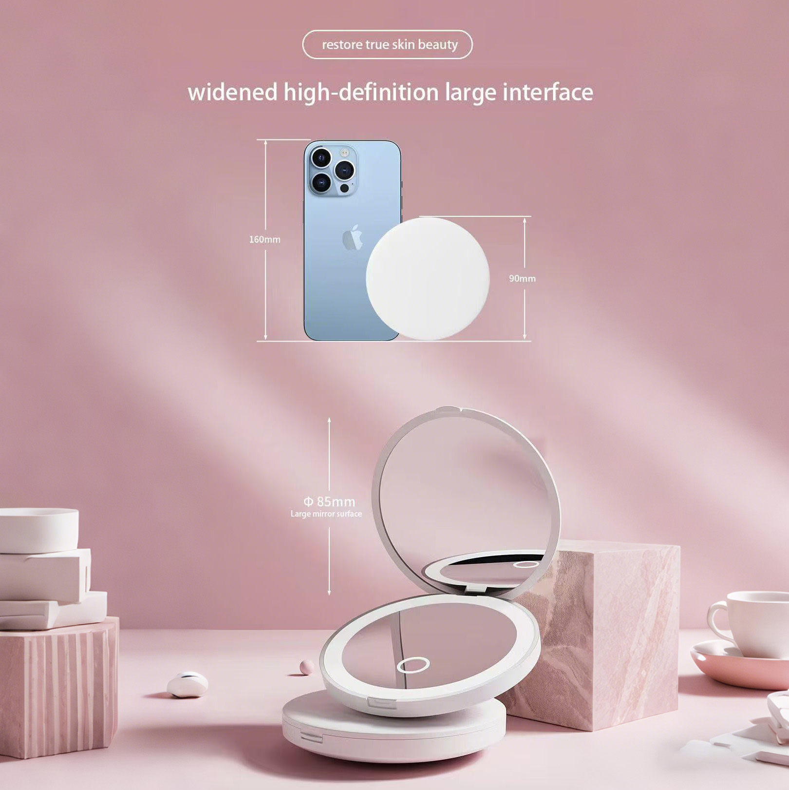 Kosmetik-Setup mit Telefon, rundem Spiegel und Kompaktspiegel auf rosa Oberfläche. Text: 'restore true skin beauty'.