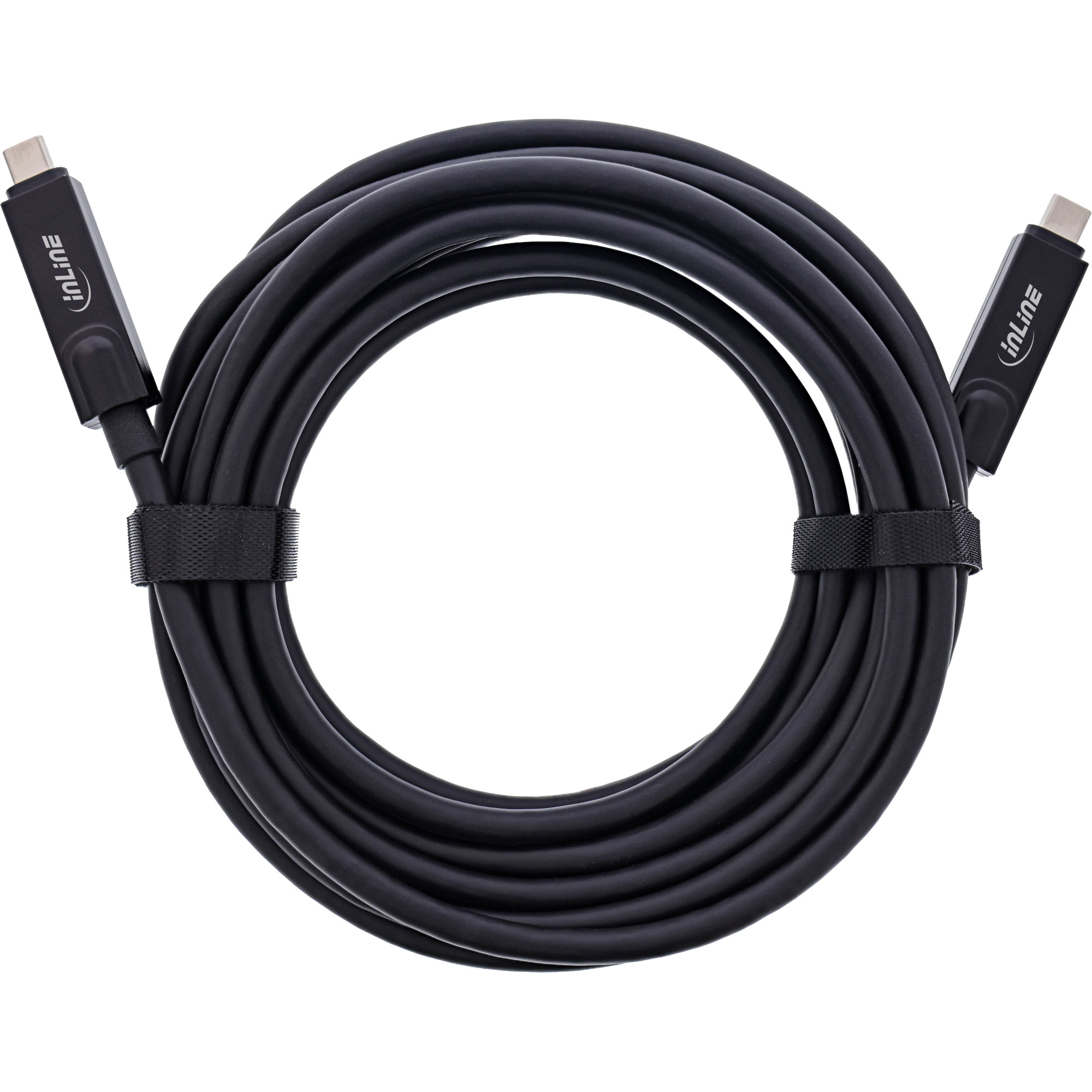 Un cavo USB-C nero arrotolato con connettori ad entrambe le estremità. Cavo fissato con una cinghia in velcro nera.