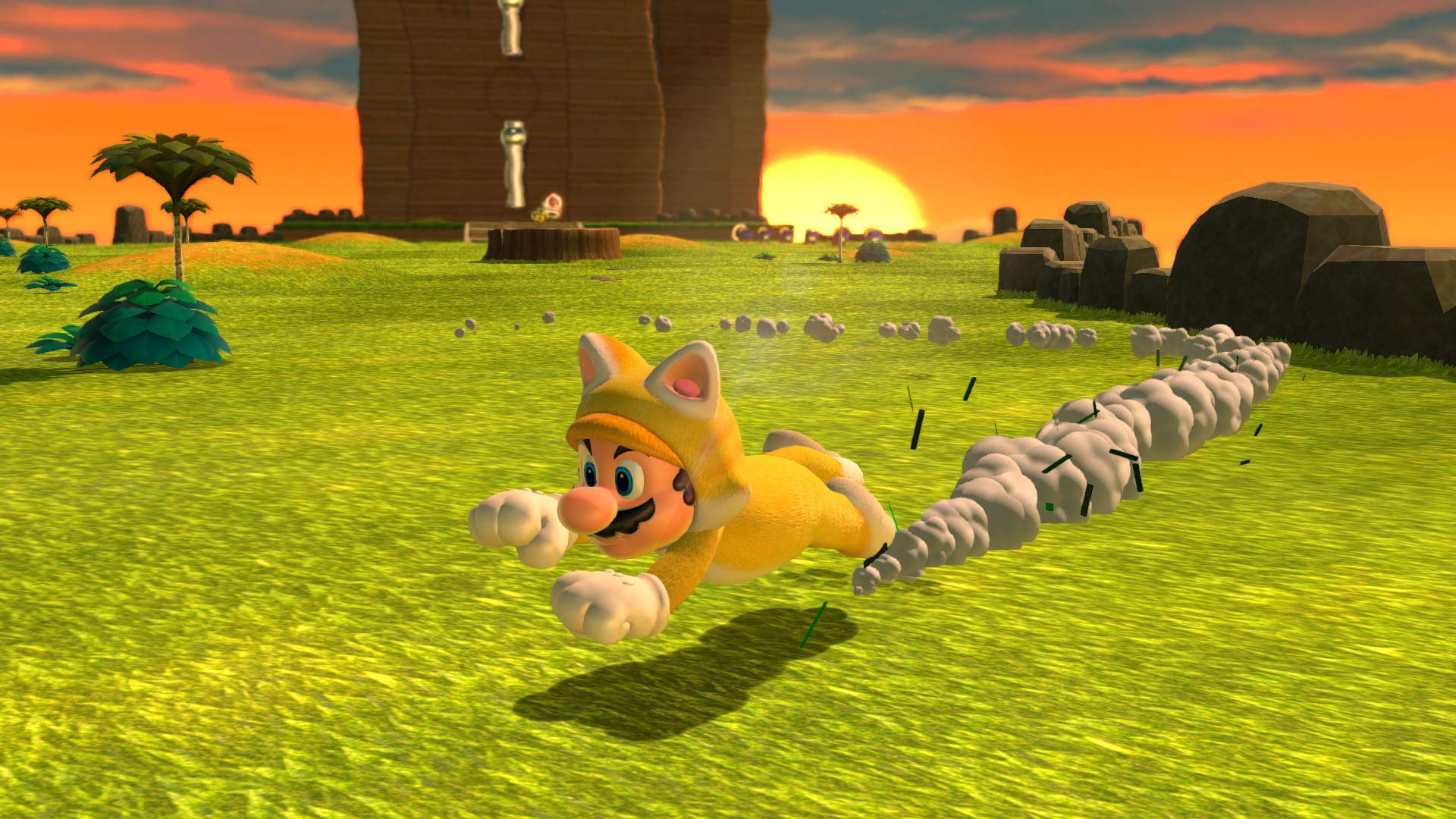 Mario, con un traje de gato, corre por un campo de hierba. Un atardecer está en el fondo, con árboles y rocas.