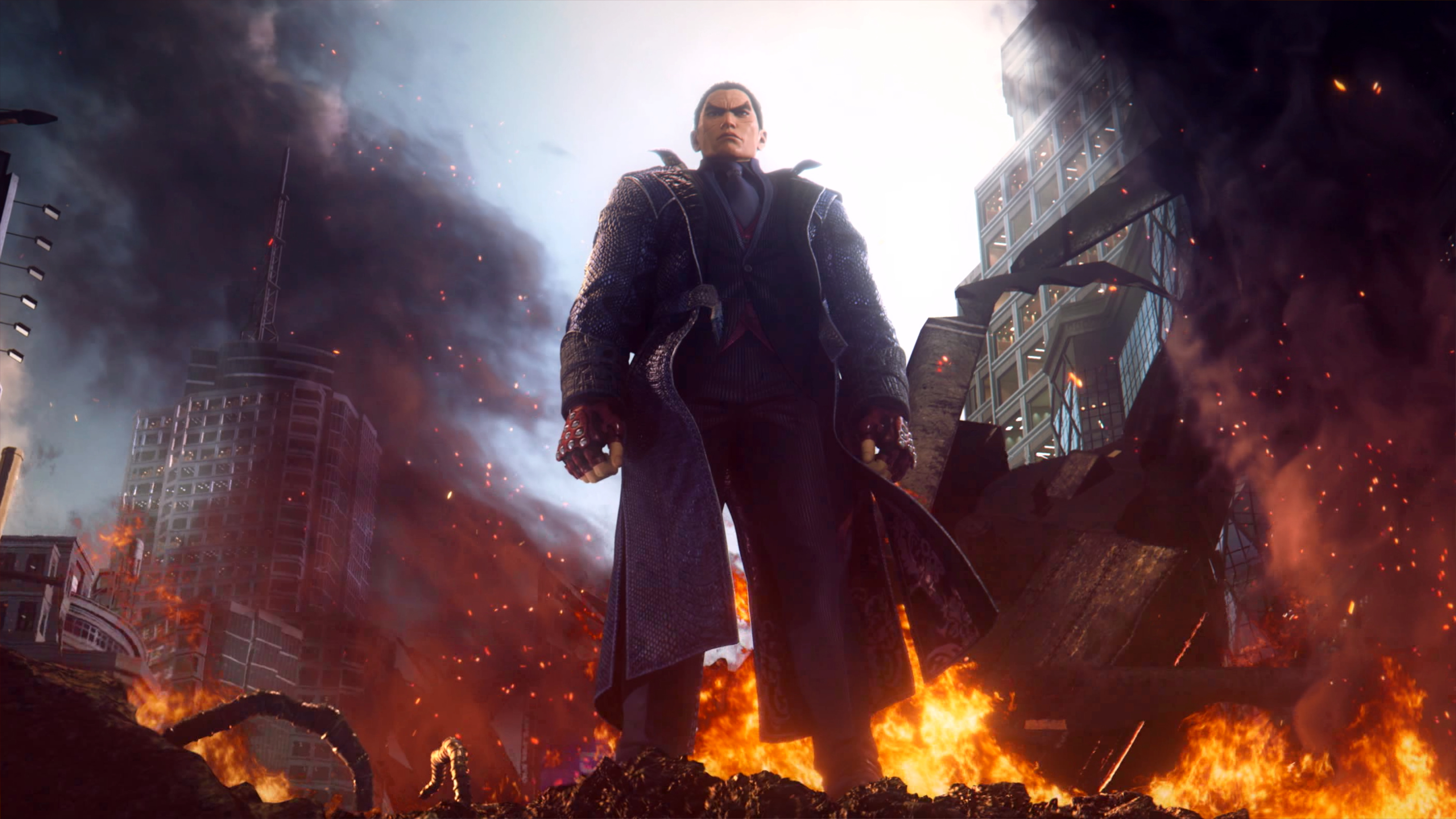 Mężczyzna stoi pośród płonącego miasta. Otaczają go płomienie i zniszczenie. Budynki się walą. Niebo jest ciemne i dymne.