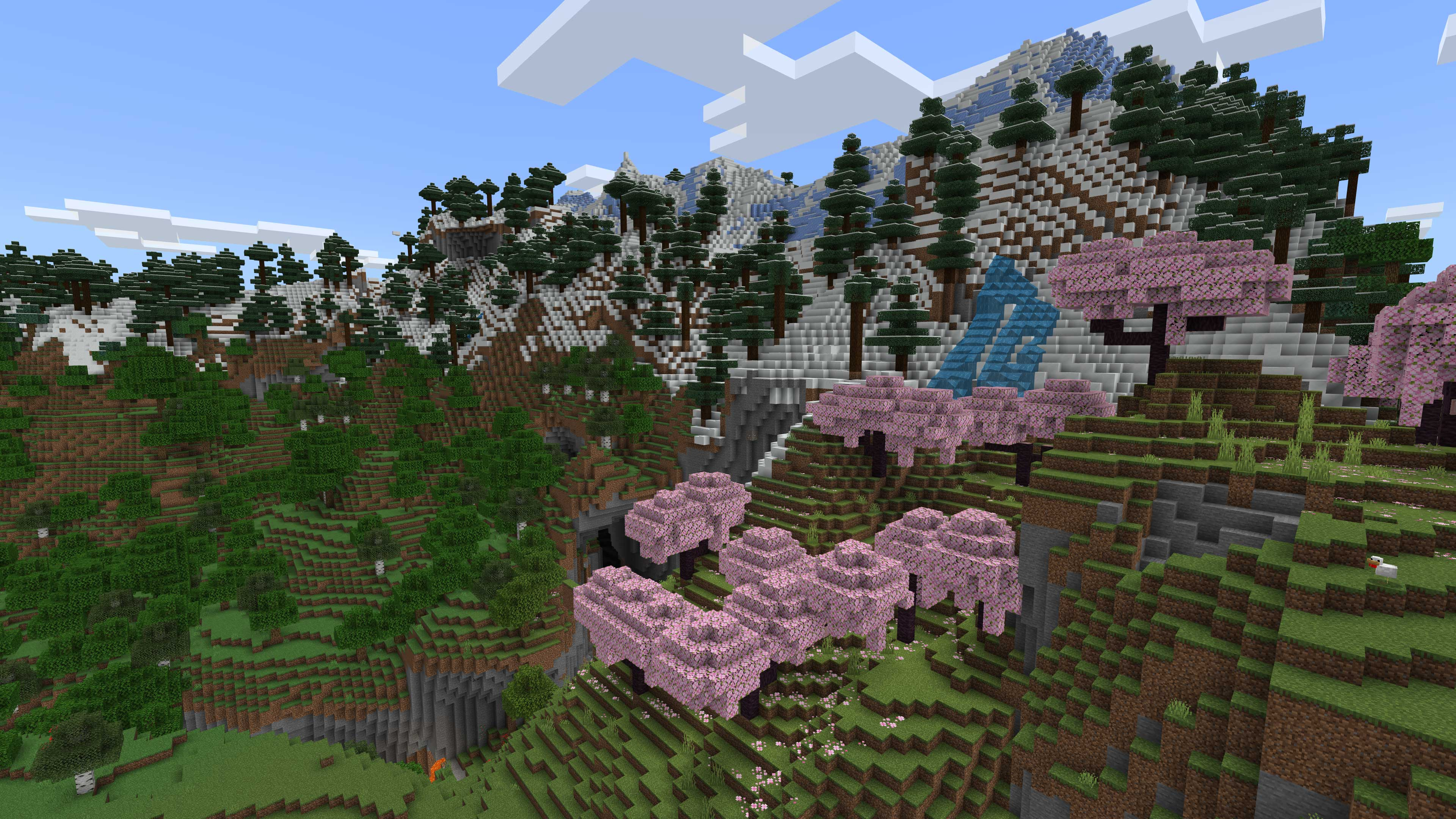 Minecraft-Landschaft mit Bergen, Bäumen, rosa blühenden Bäumen und blauem Himmel mit Wolken. Eine Höhle und ein Wasserfall sind vorhanden.