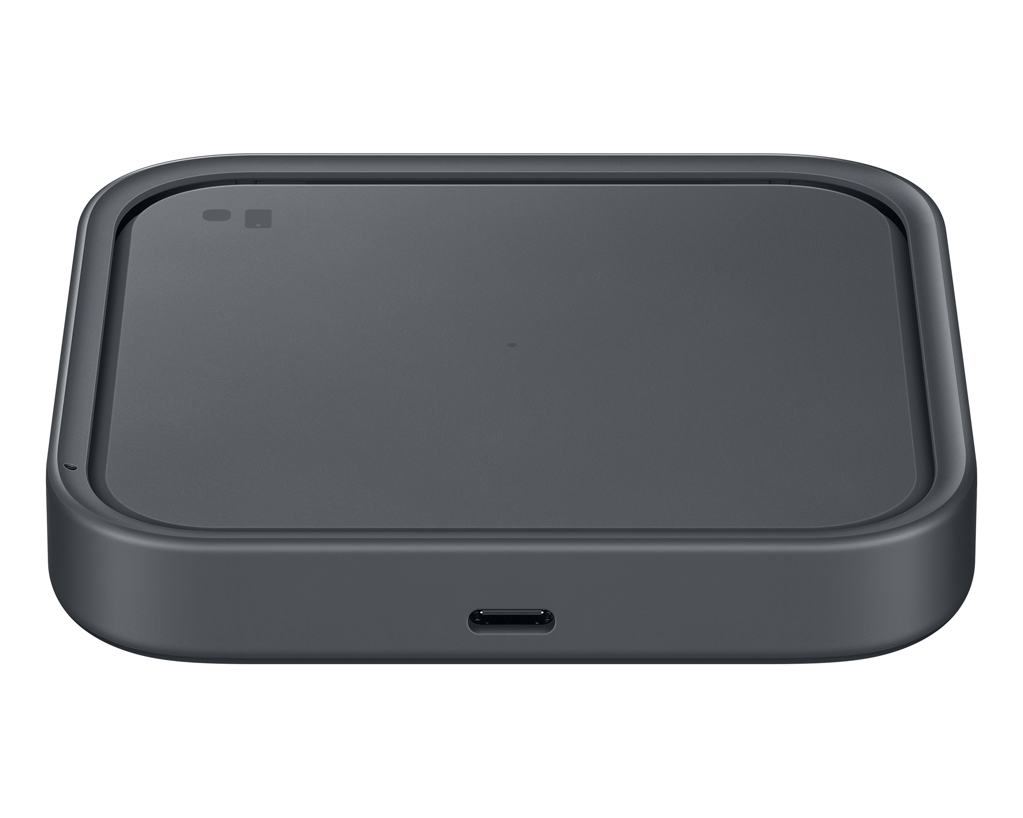 Un chargeur sans fil gris foncé. Il a une forme carrée avec des coins arrondis. Un port USB-C est en bas.