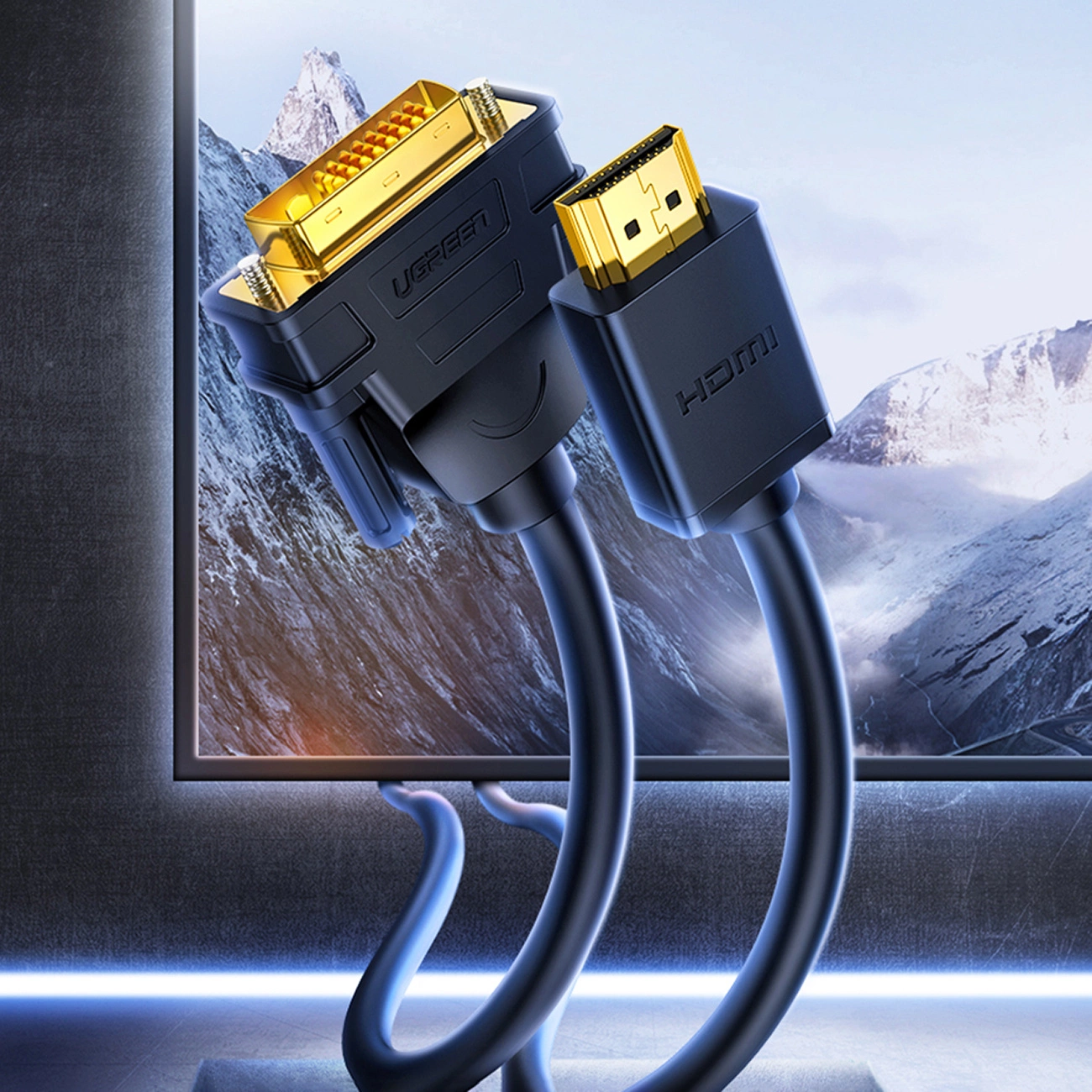 Dwa czarne kable ze złotymi złączami. Jeden ma DVI, drugi HDMI. Tło przedstawia pasmo górskie na ekranie.