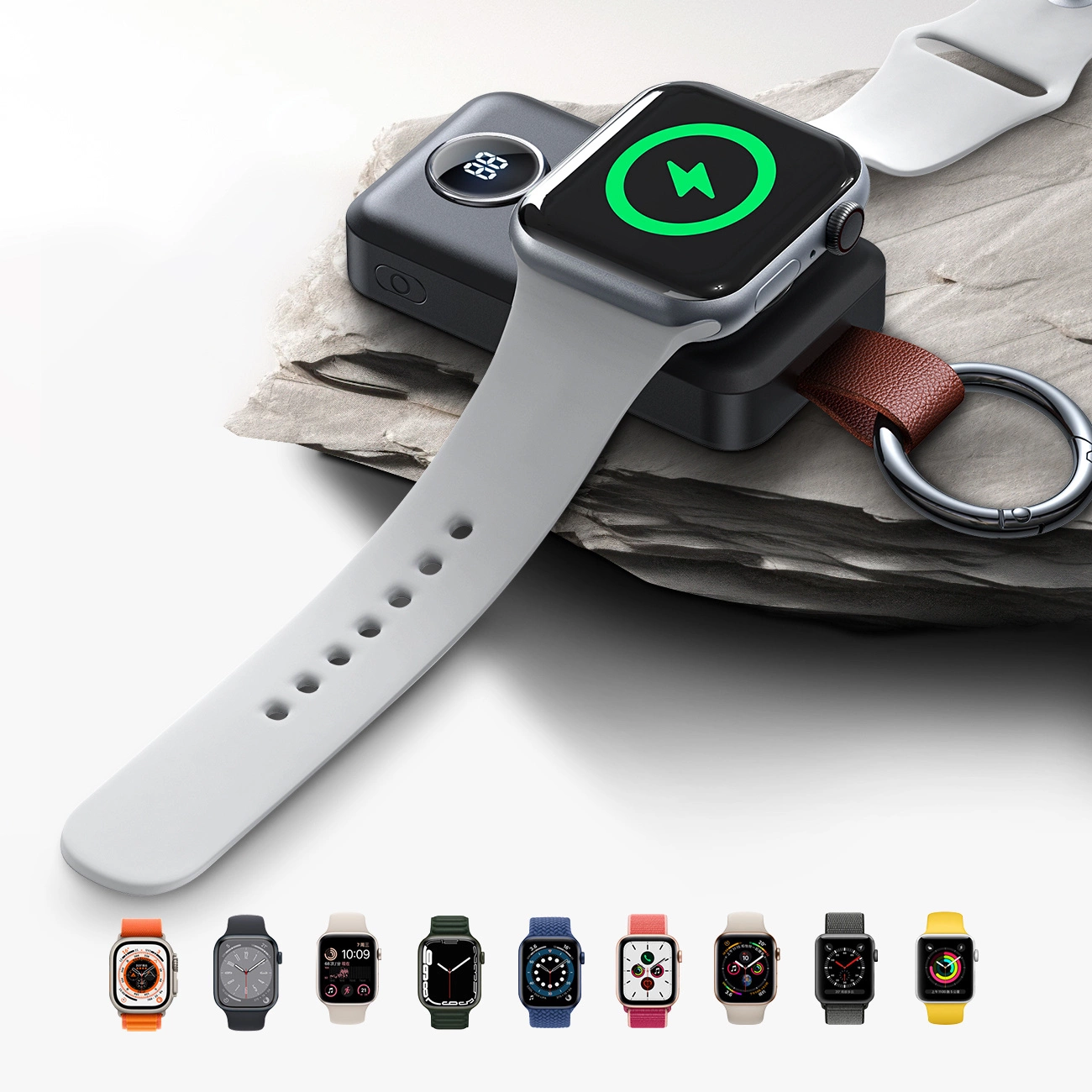 Eine Apple Watch auf einer Ladestation mit hellgrauem Armband. Unten sind mehrere farbenfrohe Zifferblätter zu sehen.