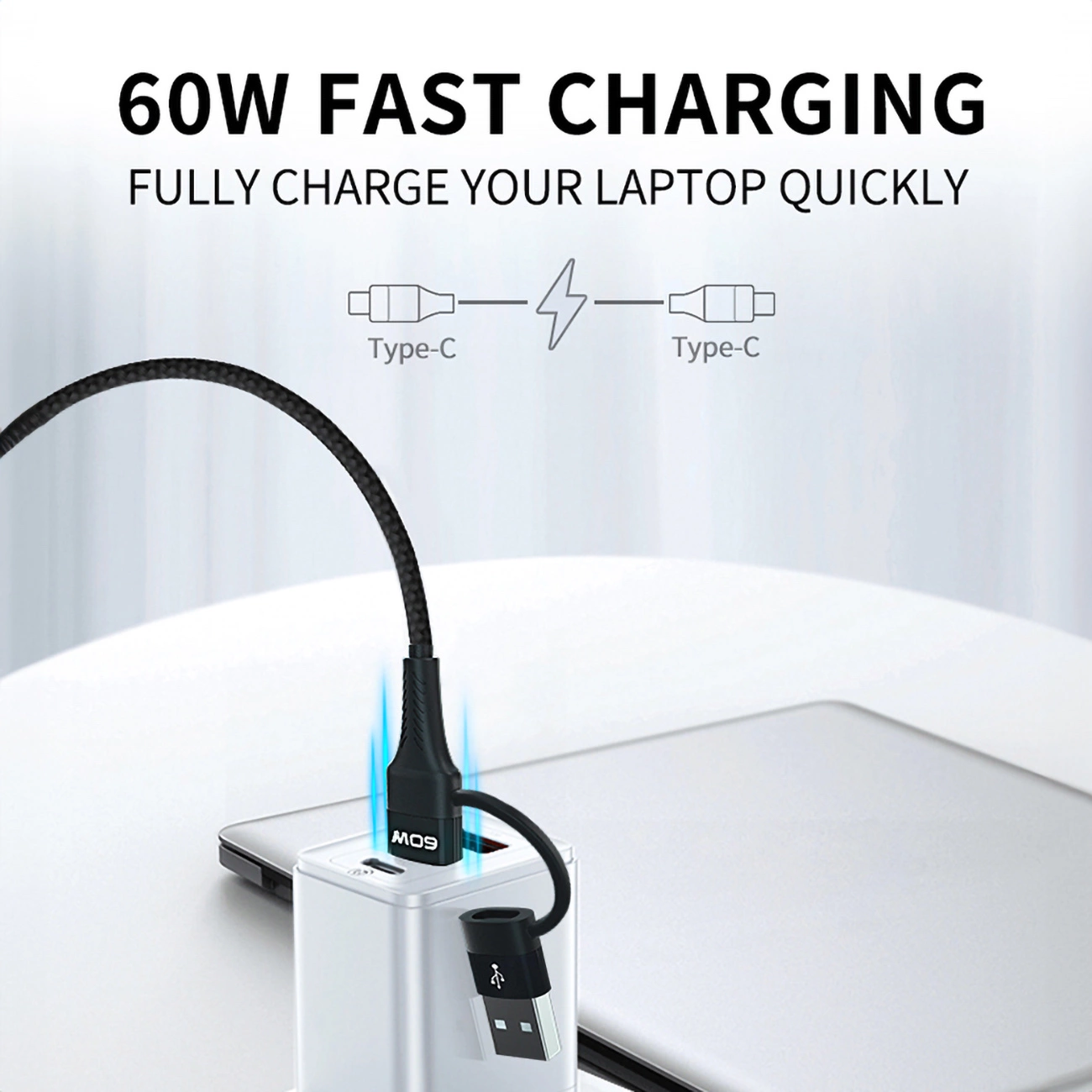 Obrazek przedstawia czarny kabel USB-C ładujący laptopa. Tekst mówi '60W FAST CHARGING'.