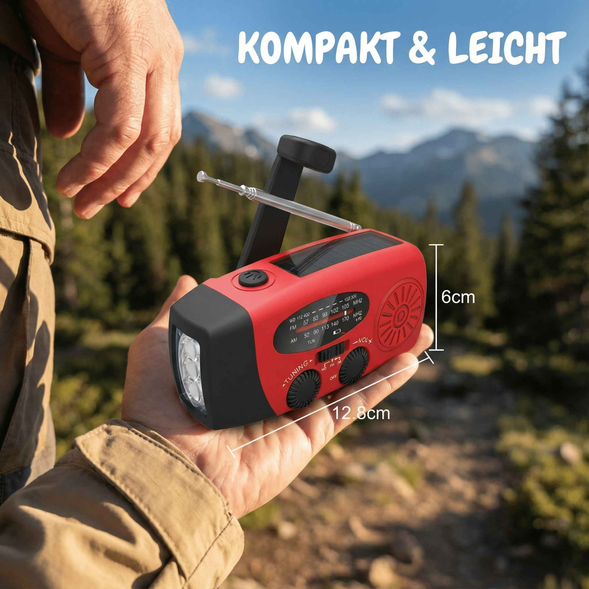 Eine Hand hält ein rotes Notfallradio mit Licht und Antenne. Im Hintergrund sind Berge zu sehen. Der Text 'KOMPAKT & LEICHT' ist sichtbar.