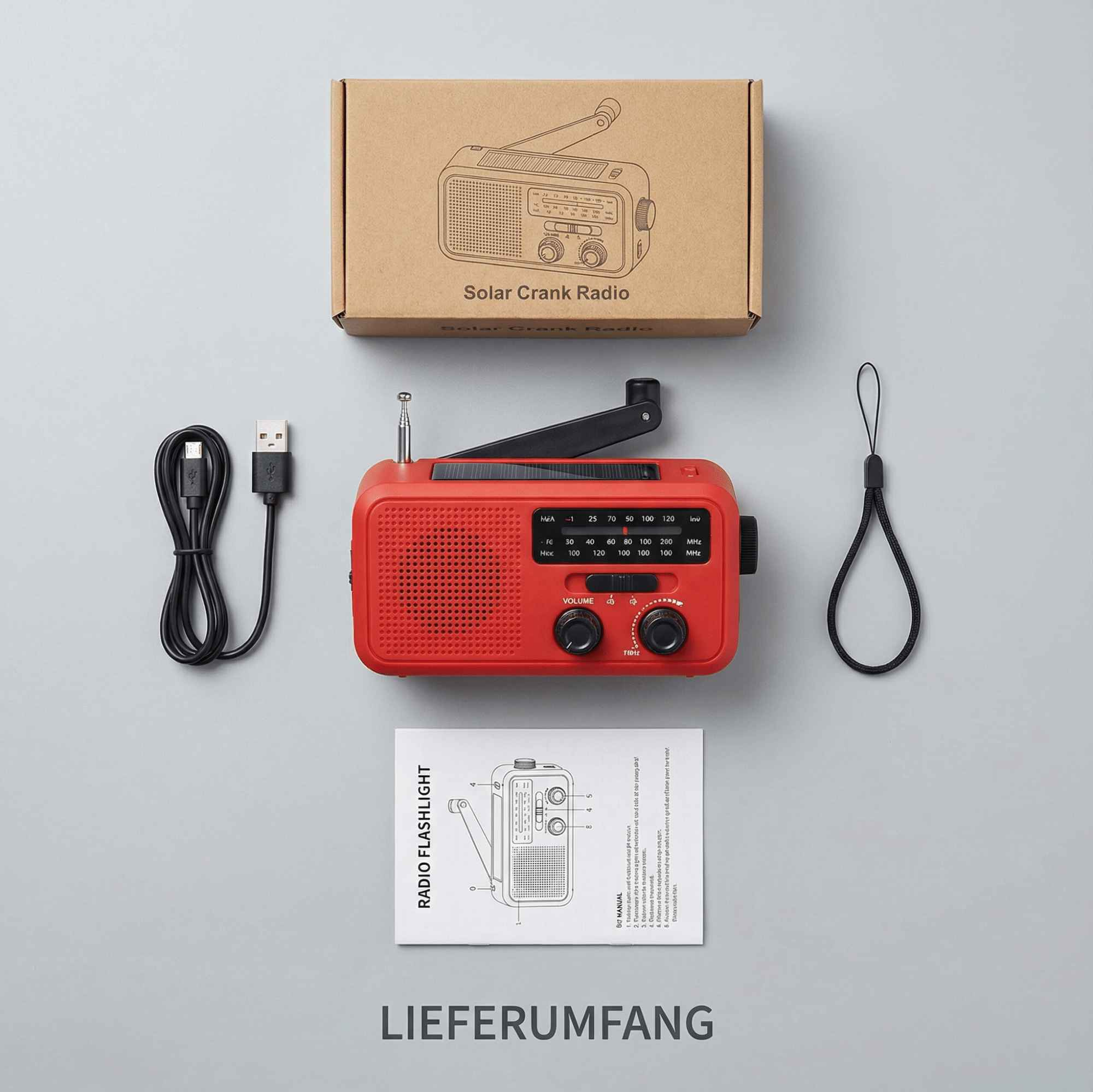 Rotes Solar-Kurbelradio mit Zubehör: Box, Kabel, Riemen und Handbuch. Komponenten auf grauem Hintergrund.