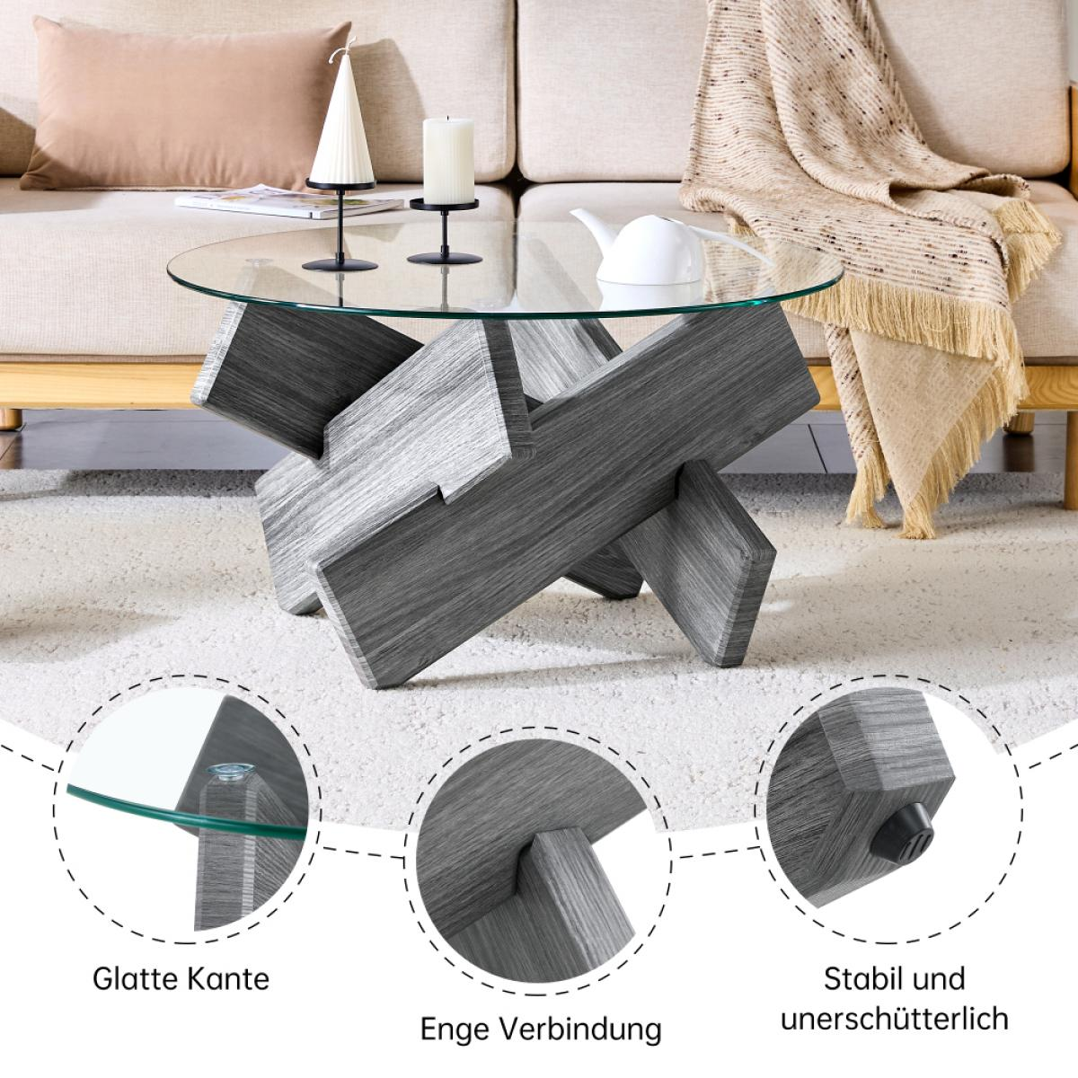Ein moderner Couchtisch mit Glasplatte und grauem Holzsockel. Kerzen und eine Teekanne stehen auf dem Tisch. Im Hintergrund ist ein Sofa.