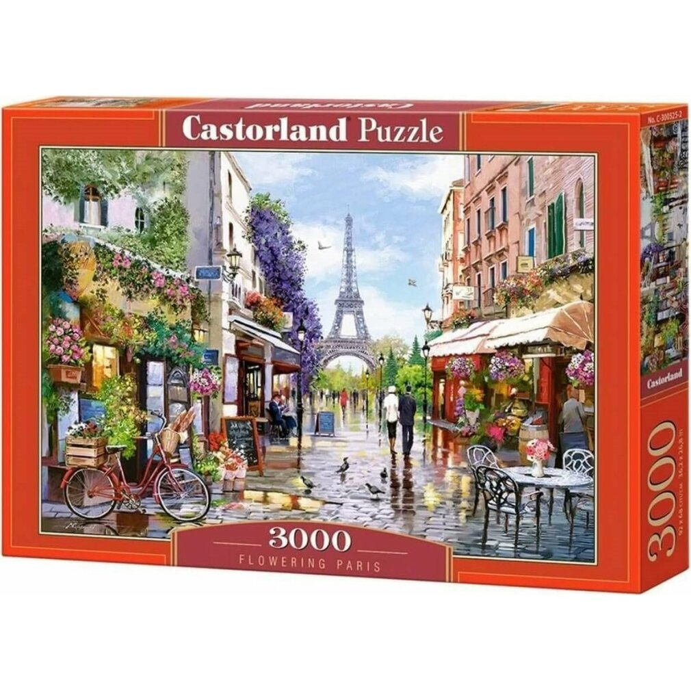 Ein Puzzlekasten mit einer Pariser Szene. Der Eiffelturm ist im Hintergrund. Geschäfte, Blumen und Menschen auf der Straße.
