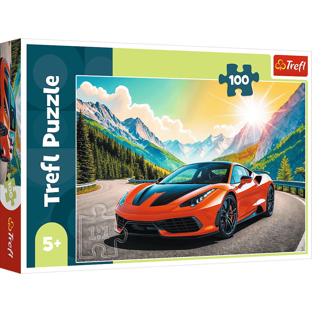 Boîte de puzzle avec une voiture de sport orange sur une route de montagne. Montagnes et soleil en arrière-plan. Le puzzle est Trefl.