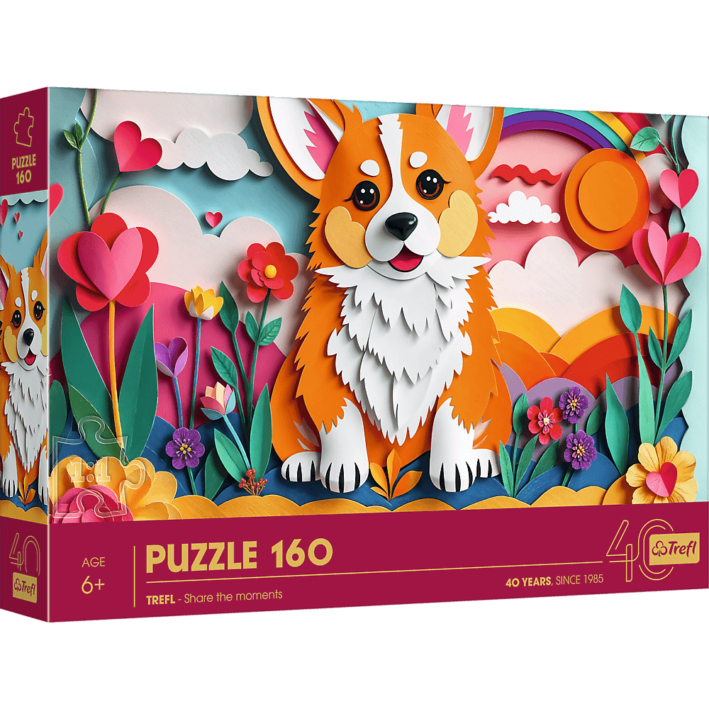 Pudełko z puzzlami z kreskówkowym corgi otoczonym papierowymi kwiatami, chmurami i tęczą. Na pudełku napis 'PUZZLE 160' i '40 LAT'.