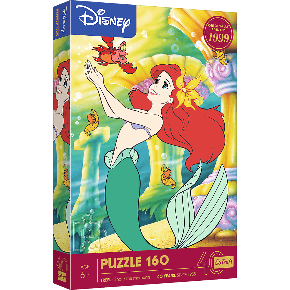 Ariel de La Petite Sirène sur une boîte de puzzle. Elle lève la main, avec Sébastien et des créatures marines autour d'elle.