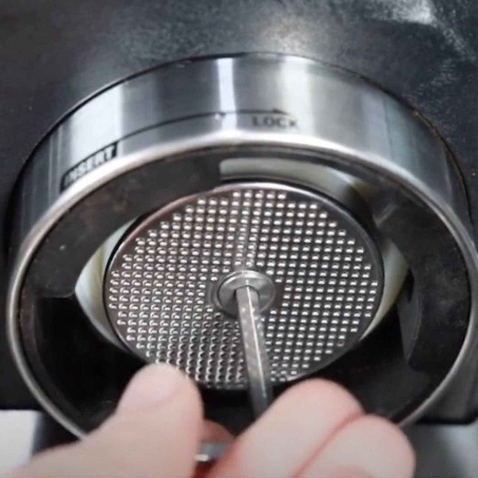 A close-up shows a grater being assembled. A hand inserts a key into the grater's center. The word 'LOCK' is visible.