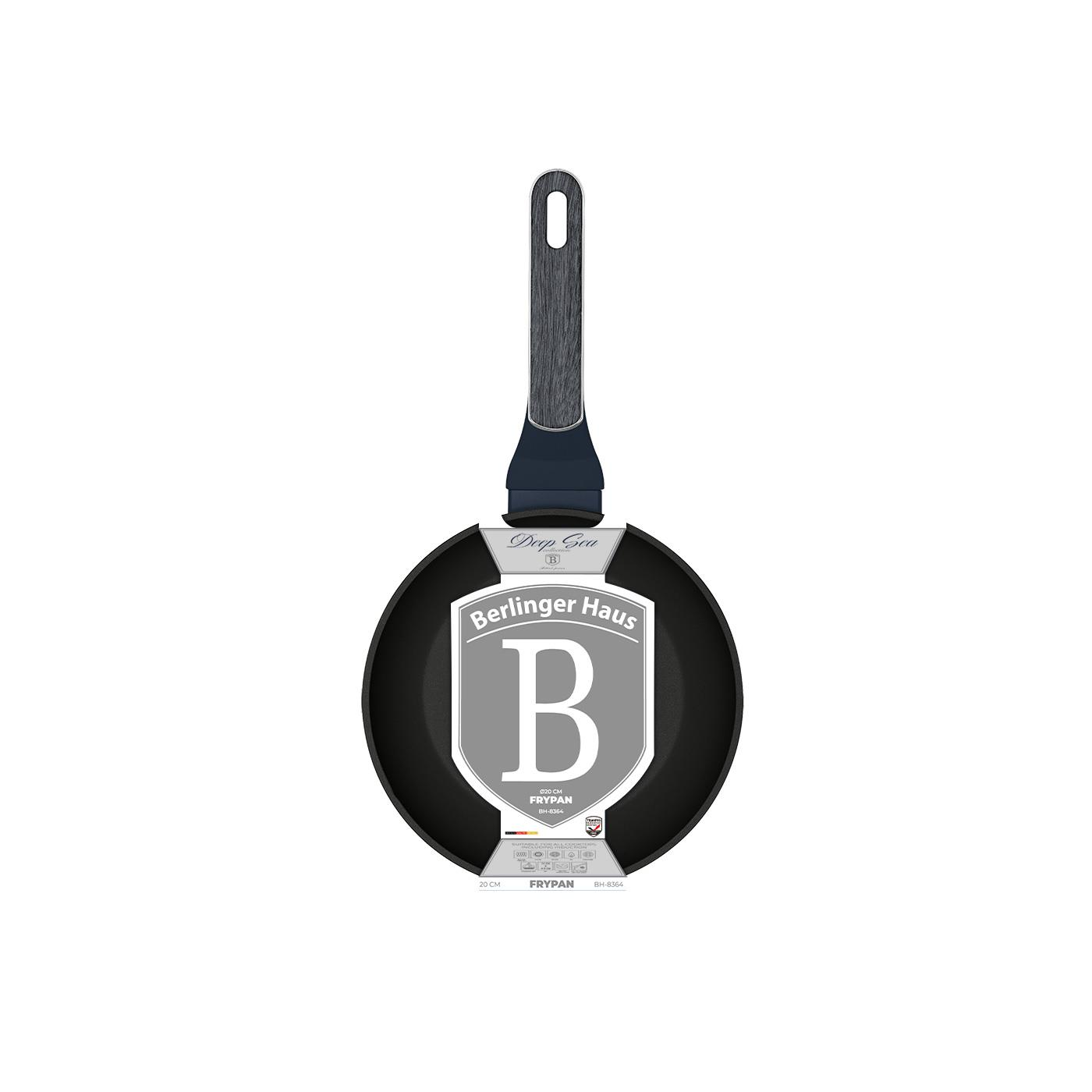 Sartén negro con mango de madera, etiquetada 'Berlinger Haus'. La sartén es redonda y el fondo es blanco.