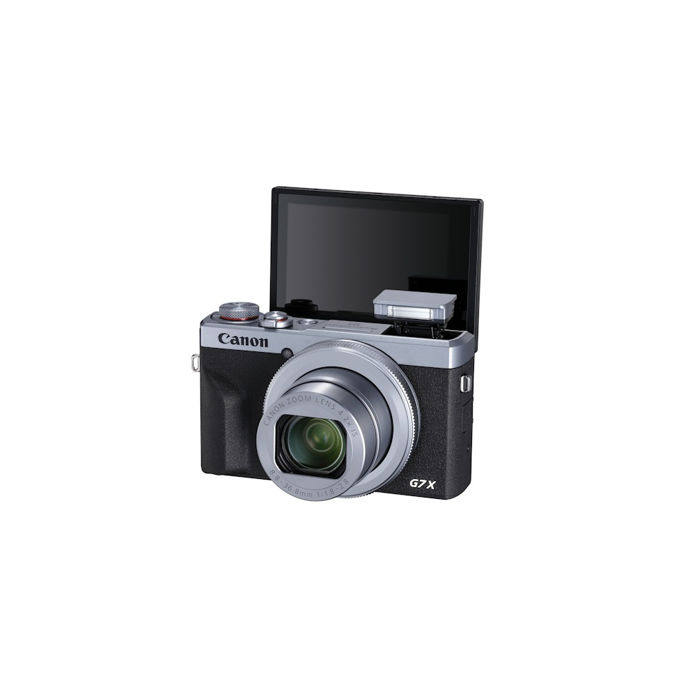 Aparat Canon G7 X z odchylanym ekranem. Obiektyw jest srebrny, a obudowa czarna i srebrna. Błysk jest otwarty.