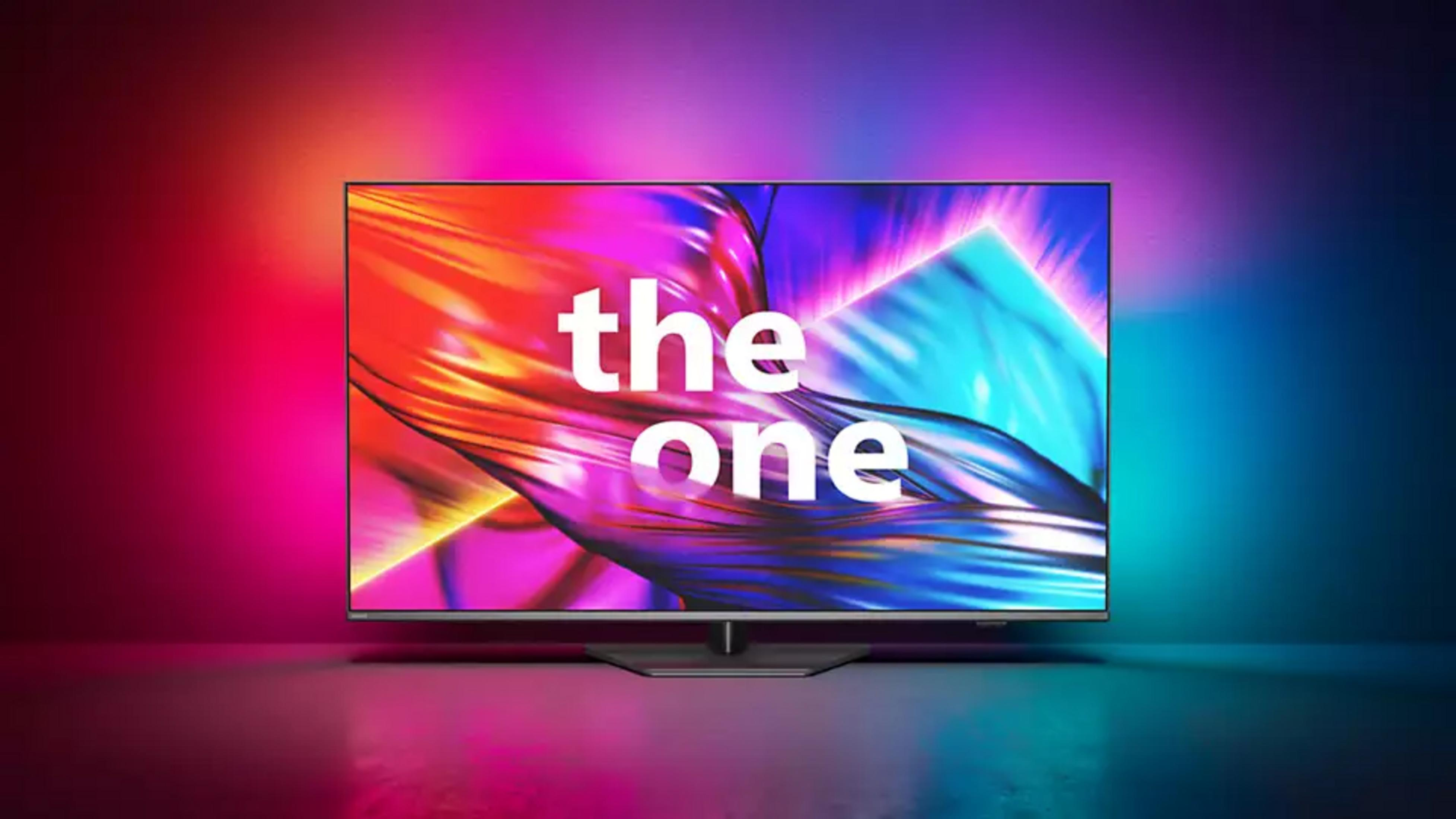 Un televisor muestra las palabras 'the one' con un fondo abstracto y colorido. El televisor está sobre una superficie reflectante.