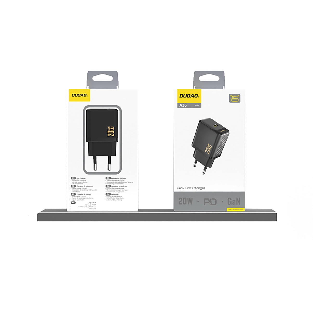 Dwie czarne ładowarki DUDO w pudełkach, jedna prosta, druga pod kątem. Obie pokazują 20W. Na pudełku po prawej stronie napis 'GaN Fast Charger'.