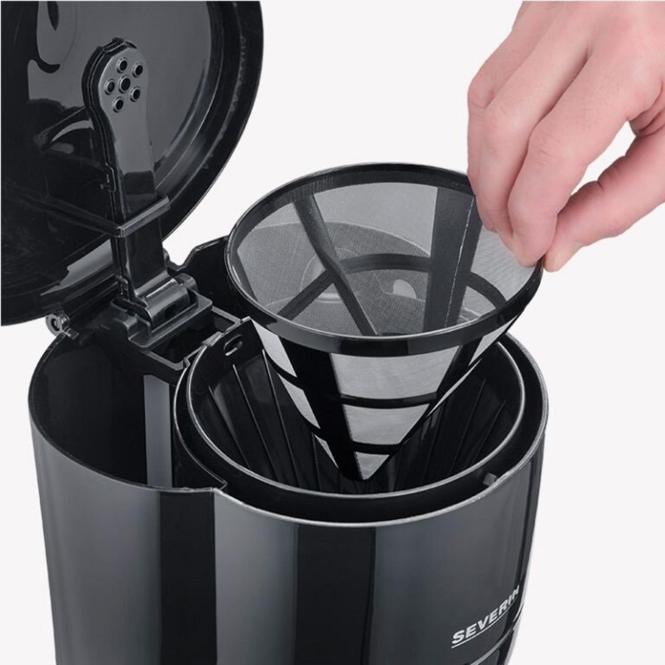 A hand placing a mesh filter into a black coffee maker. The machine is open. The brand is Severin.