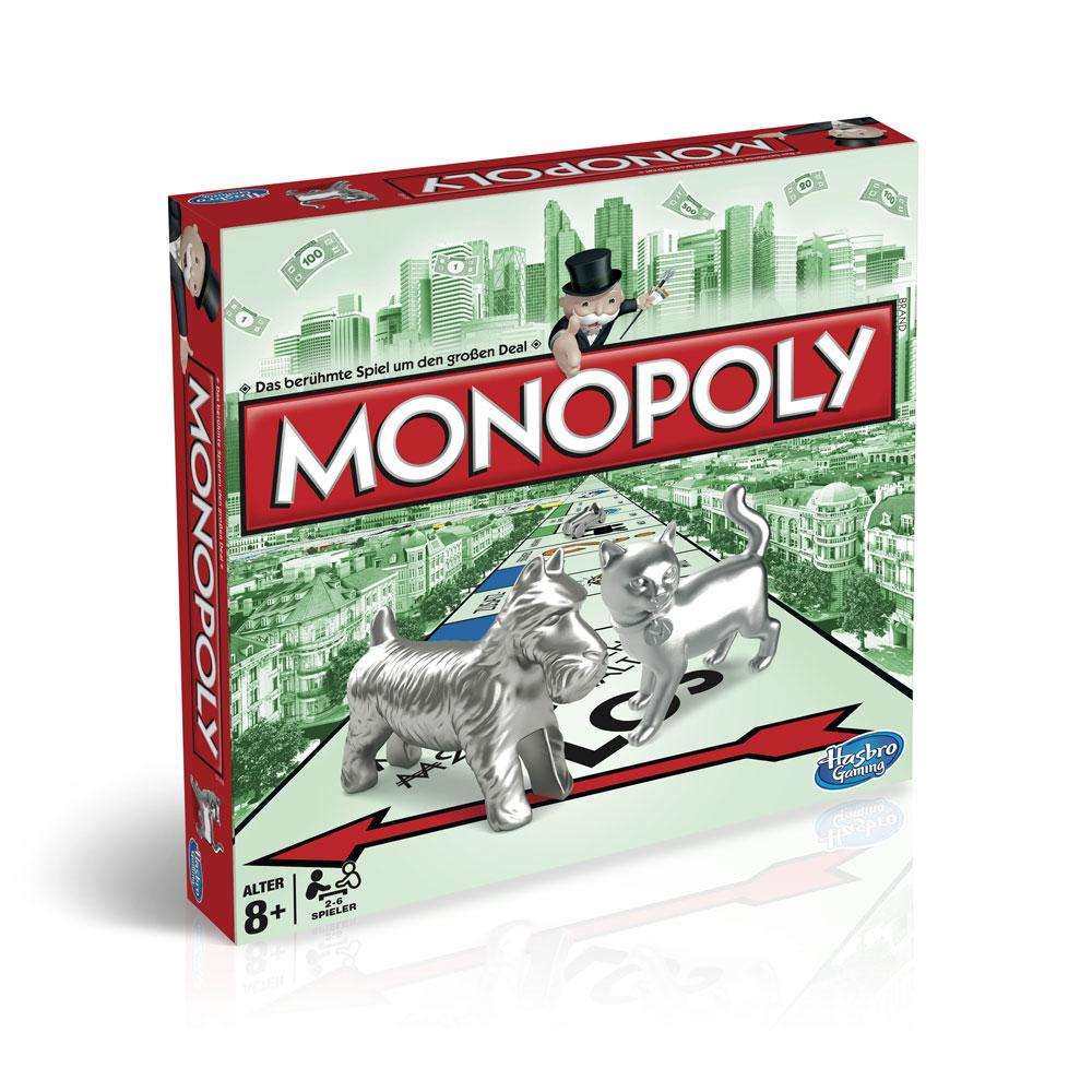 Monopoly-Brettspielbox. Enthält den Spieletitel, silberne Spielsteine (Hund, Katze), Stadtlandschaft und Monopoly-Mann. Rotes und grünes Farbschema.