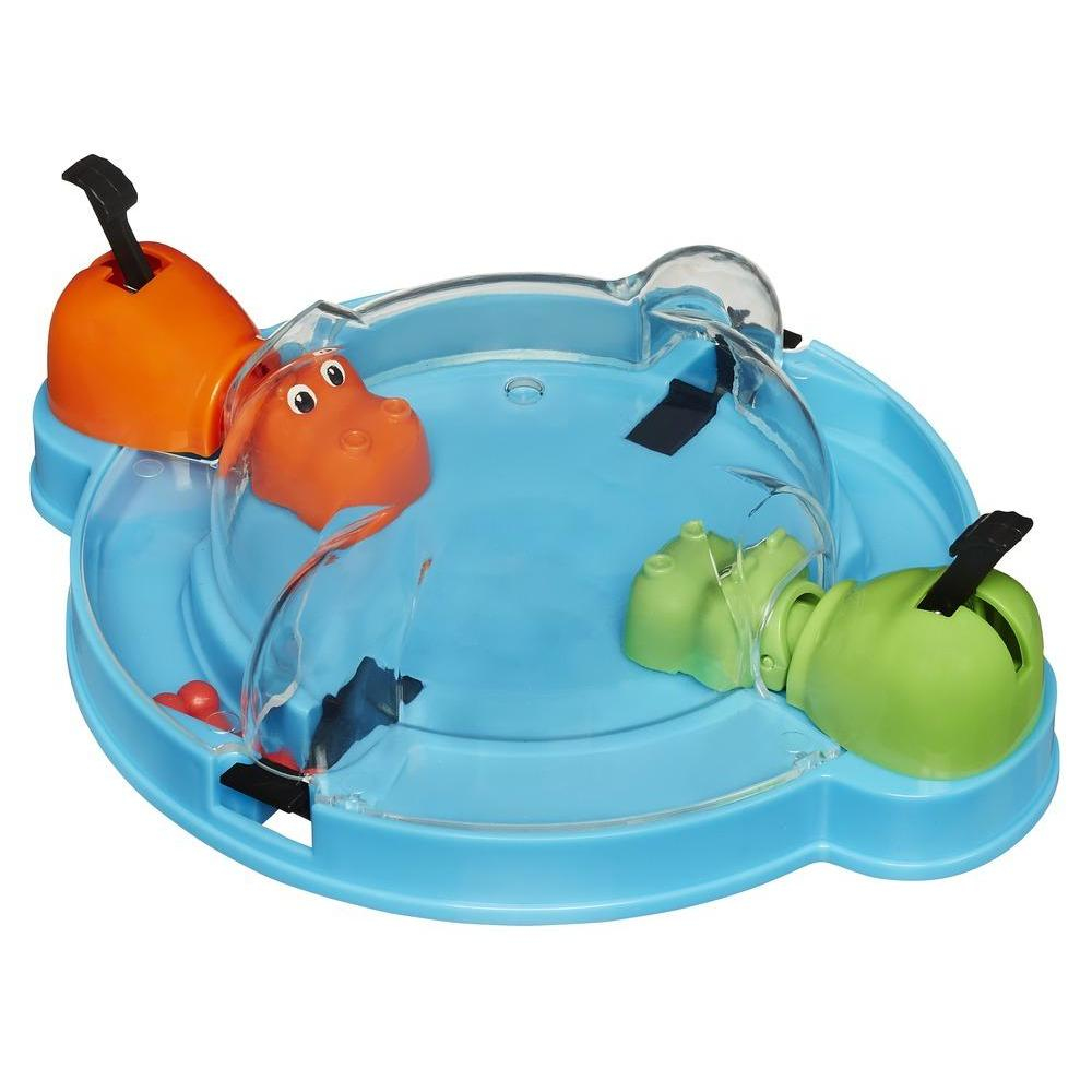 Ein Hungry-Hungry-Hippos-Spiel. Drei Flusspferde in Orange und Grün, mit blauem Sockel und klarer Kunststoffabdeckung, bereit, Murmeln zu fressen.