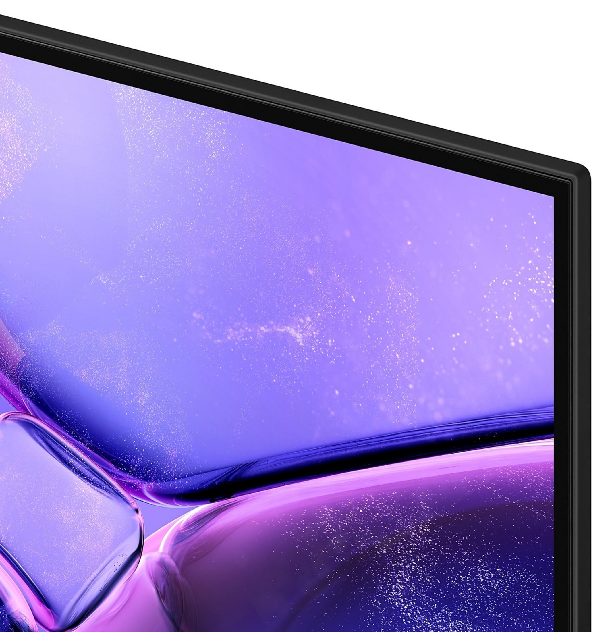 Primer plano de una pantalla con un diseño abstracto púrpura y blanco. Marco negro alrededor.