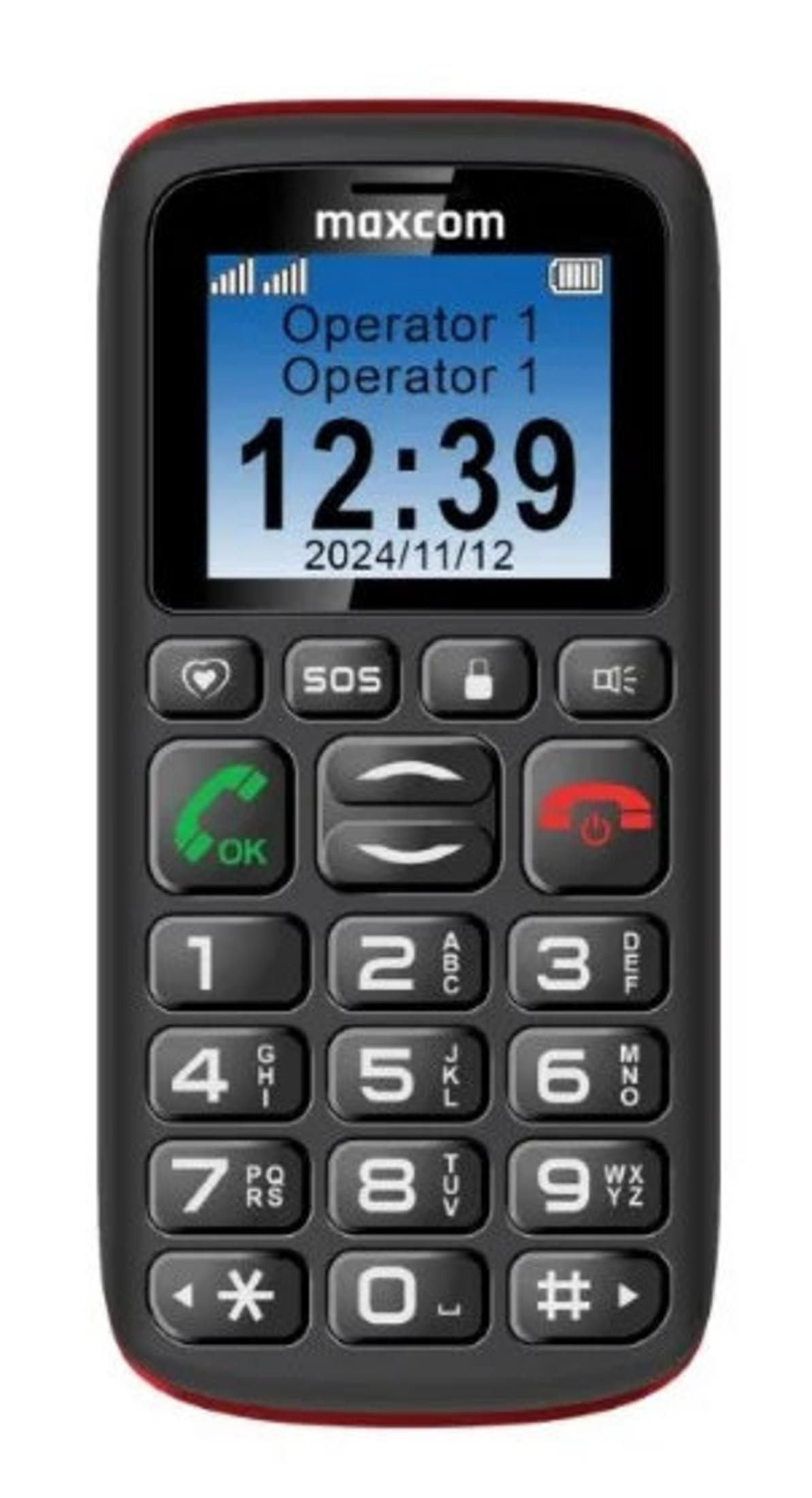 Un telefono cellulare Maxcom nero con bordo rosso. Lo schermo mostra l'ora 12:39 e la data 2024/11/12. Ha dei pulsanti.