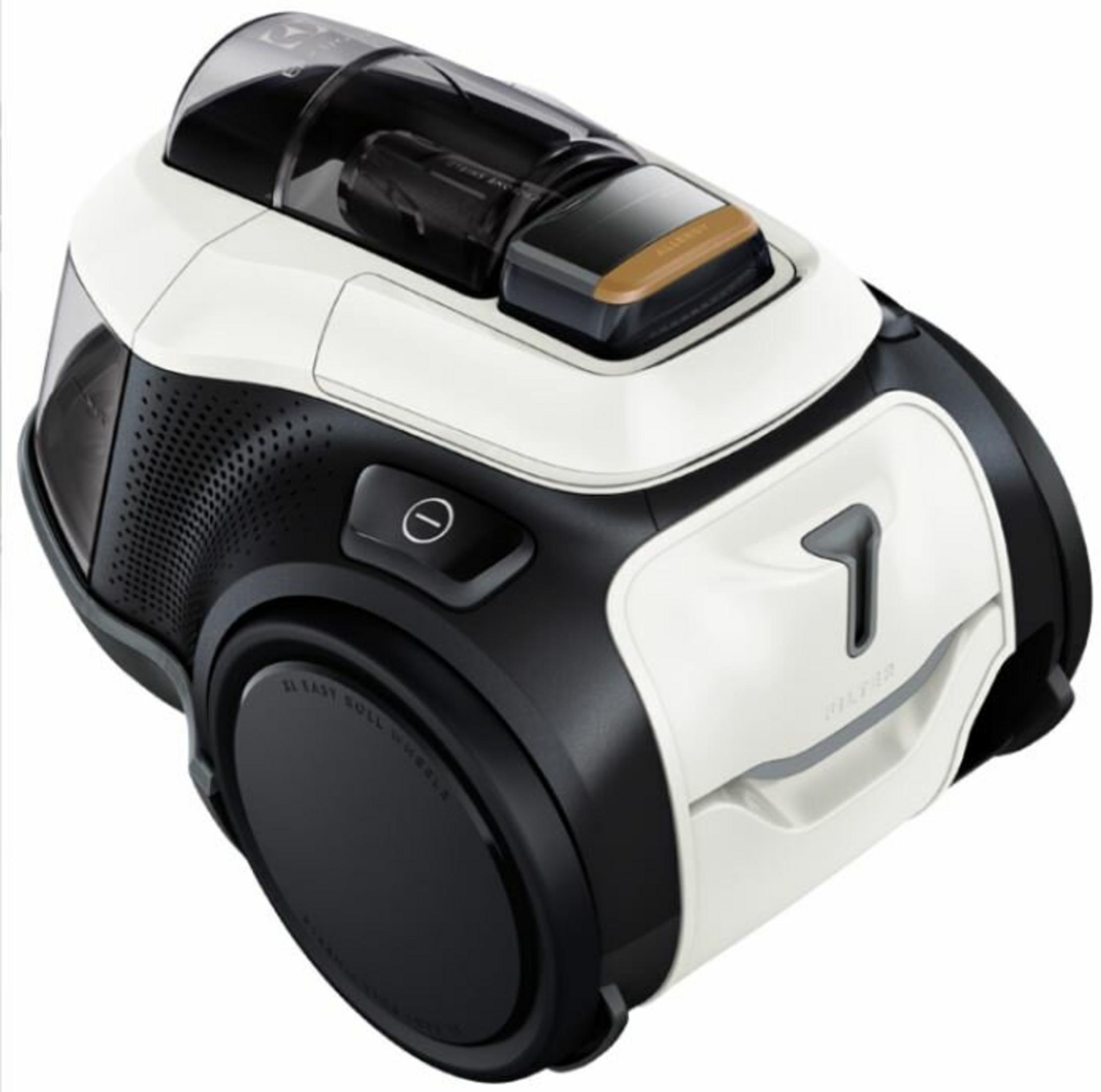 Biało-czarny odkurzacz z przezroczystą pokrywą i brązowymi akcentami, na białym tle.