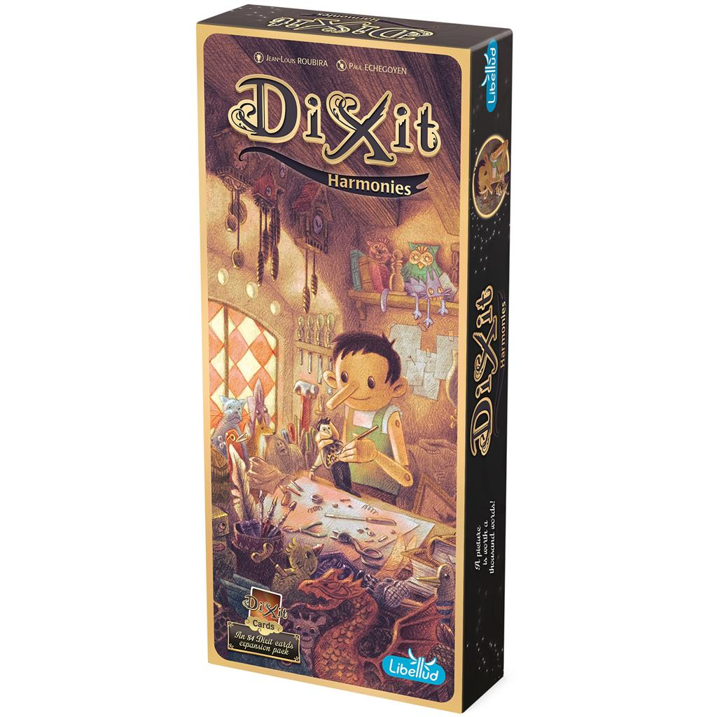 La caja Dixit Harmonies muestra una escena ilustrada con un personaje creando en un taller, con el logo de Dixit prominente.