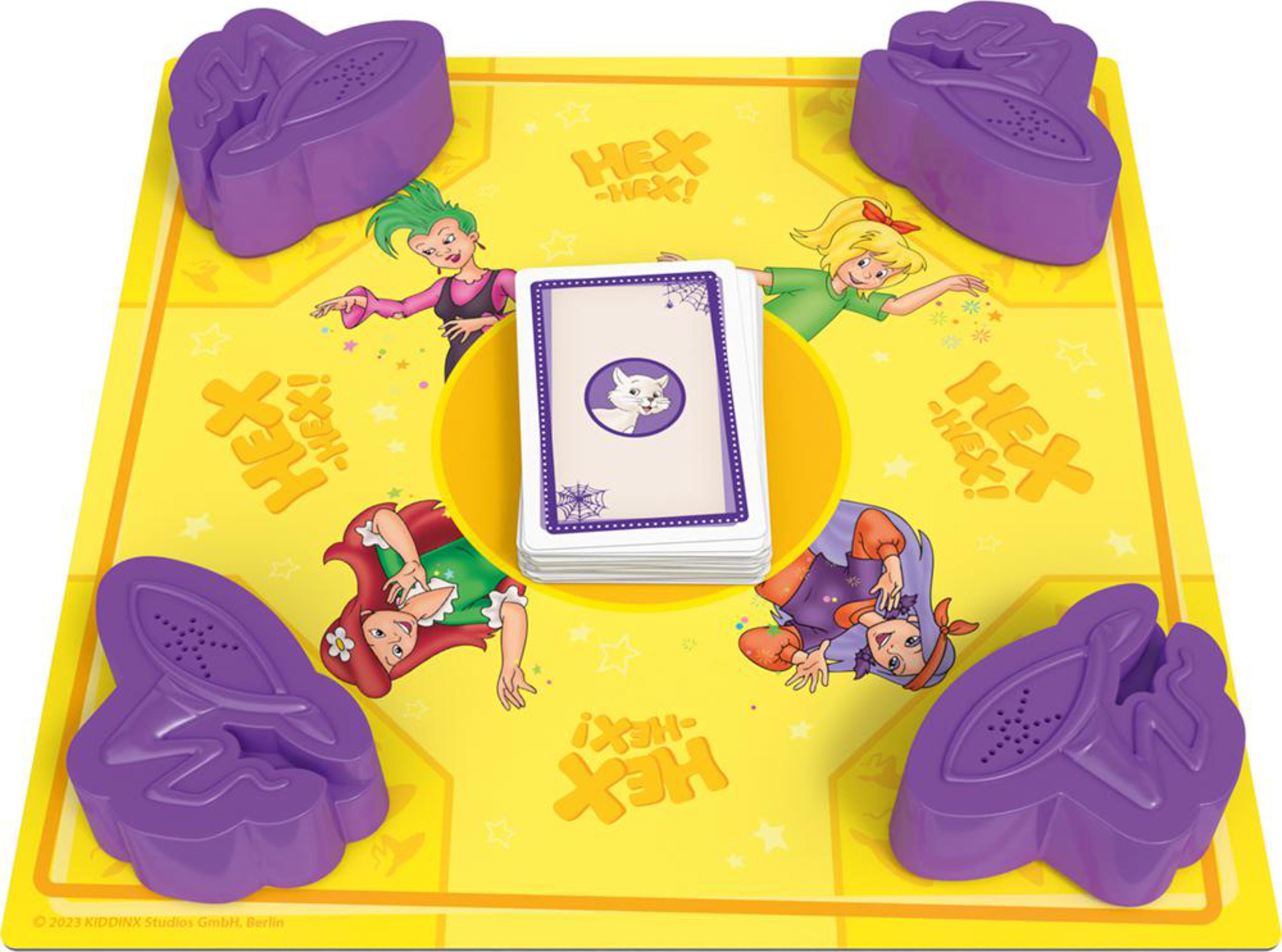Un jeu de société jaune avec des pièces violettes et des personnages de dessins animés, avec des cartes avec une icône de chat blanc.
