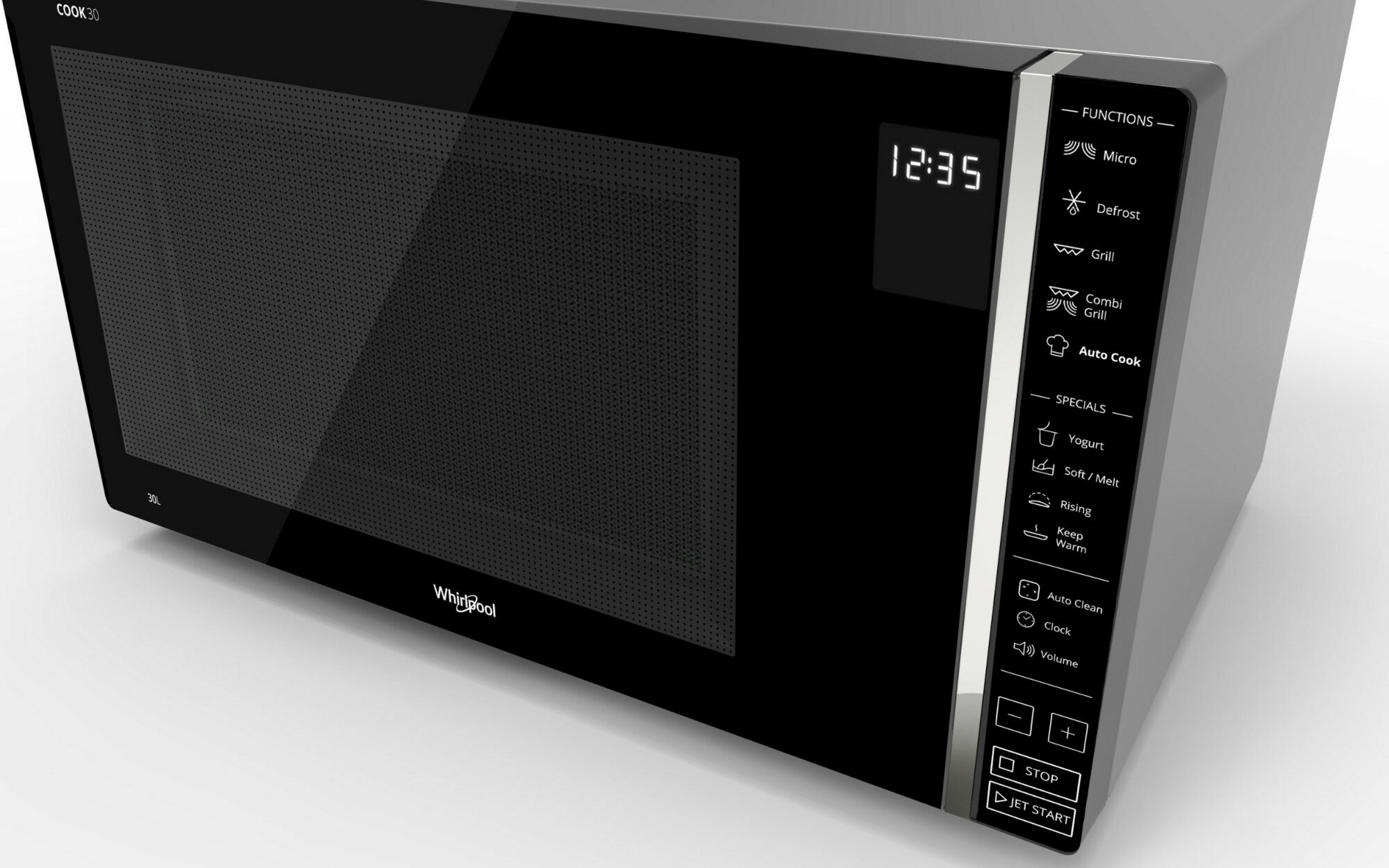 Ein schwarzes Whirlpool-Mikrowellengerät mit Knöpfen, einer Digitaluhr und Funktionsoptionen. 12:35 wird angezeigt.