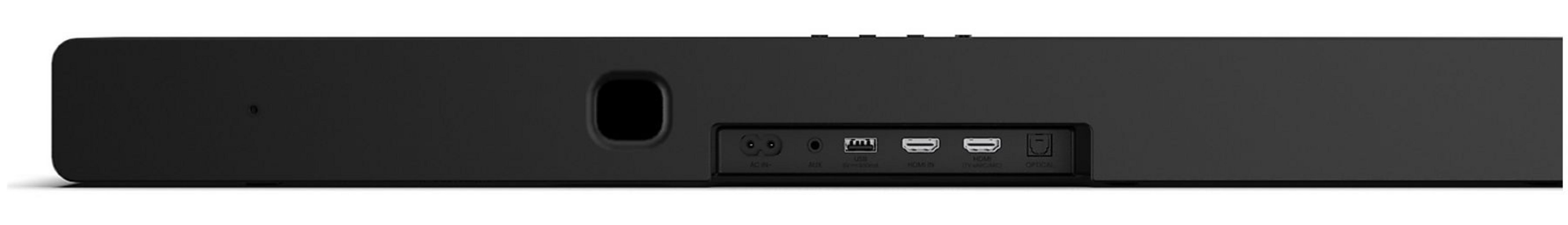 Une barre de son noire avec plusieurs ports à l'arrière, dont HDMI, USB et AUX, sur une surface blanche.