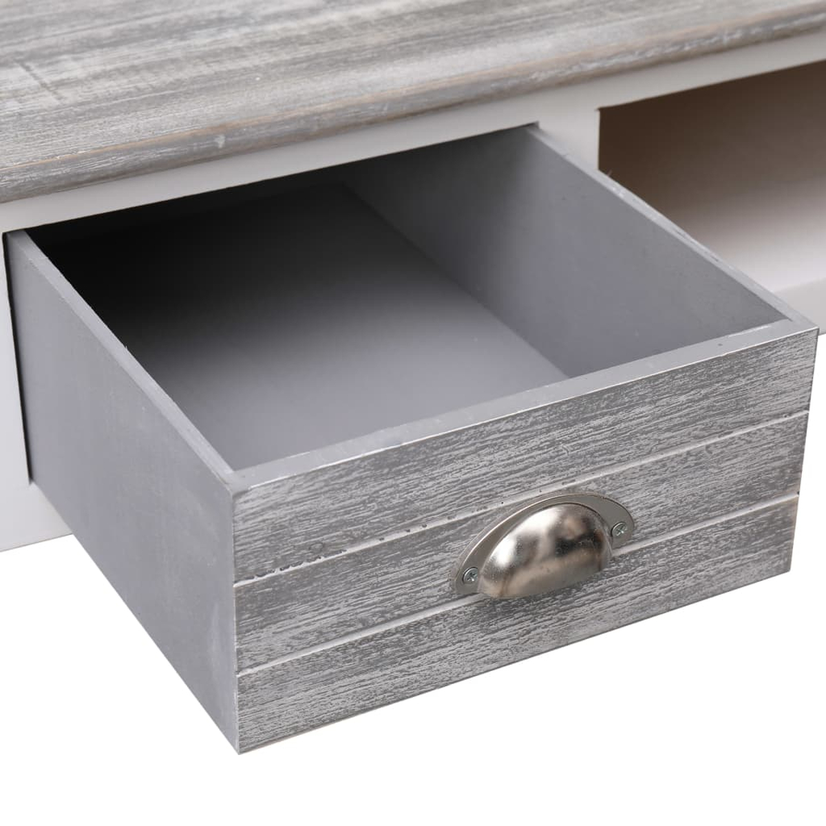 Offene graue Schublade mit Metallgriff. Die Schublade ist Teil eines grau-weißen Holzmöbels.