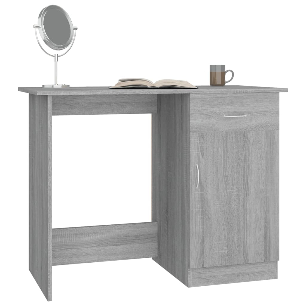 Ein grauer Schreibtisch mit Spiegel, offenem Buch und Tasse. Er hat rechts eine Schublade und einen Schrank.