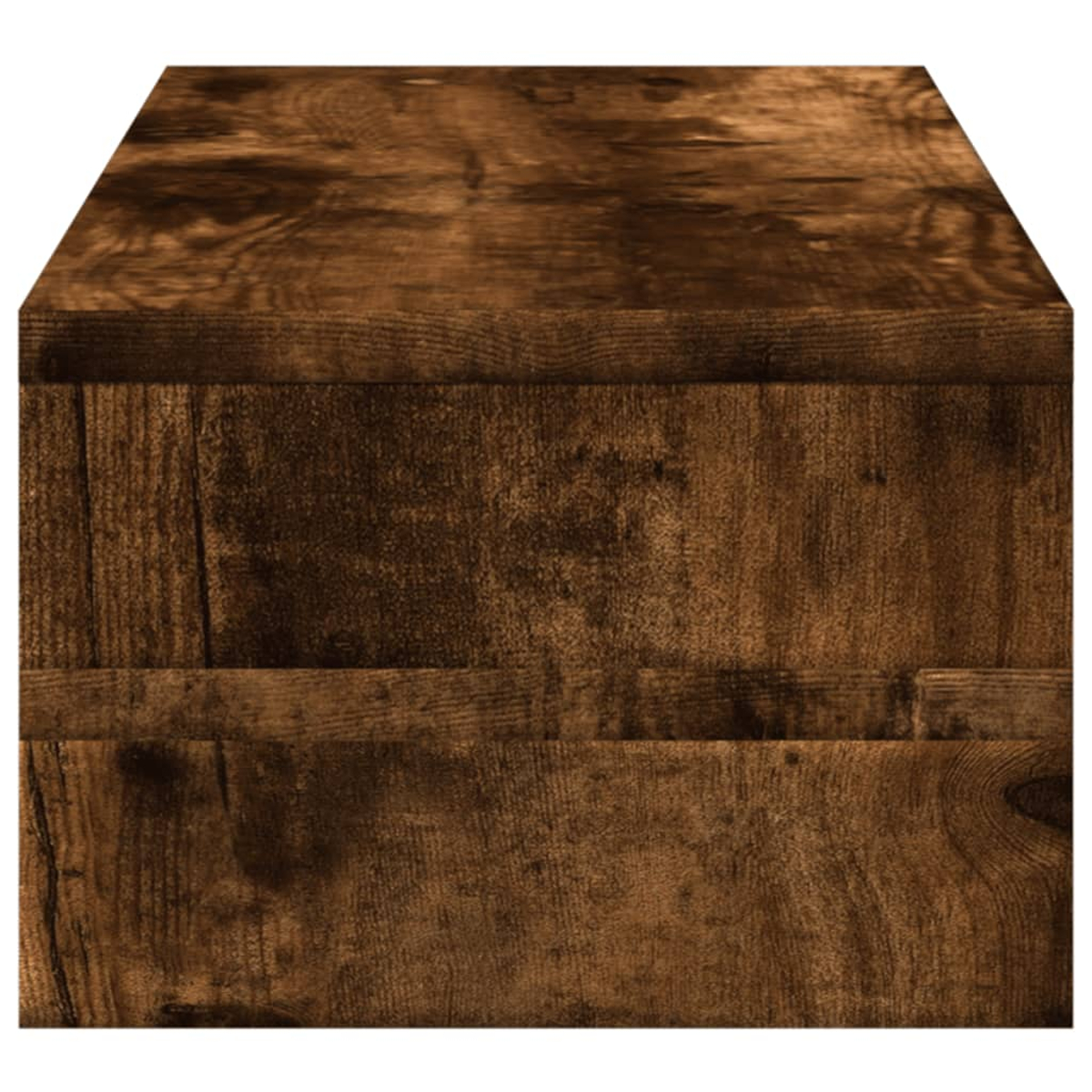 Nahaufnahme eines Holzblocks mit sichtbarer Maserung. Das Holz hat eine dunkelbraune Farbe. Der Block scheint ein Tisch oder eine ähnliche Struktur zu sein.