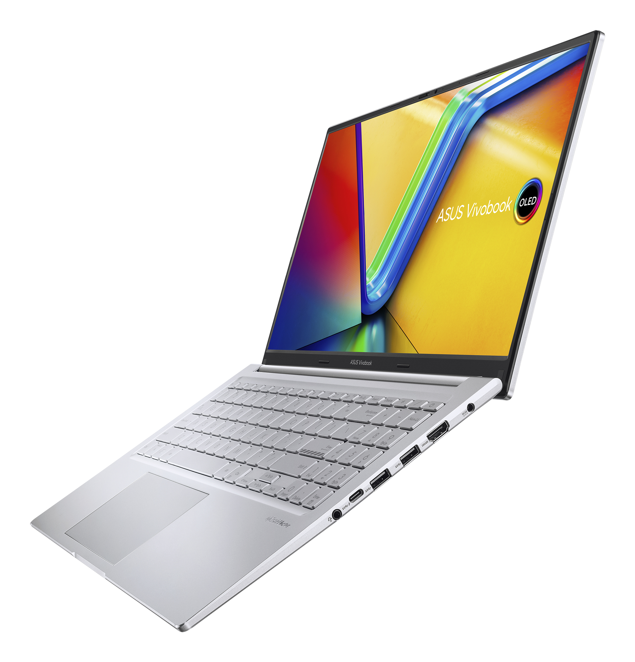 Srebrny laptop Asus Vivobook jest ustawiony pod kątem w górę. Ekran wyświetla kolorowy design, klawiatura jest widoczna.