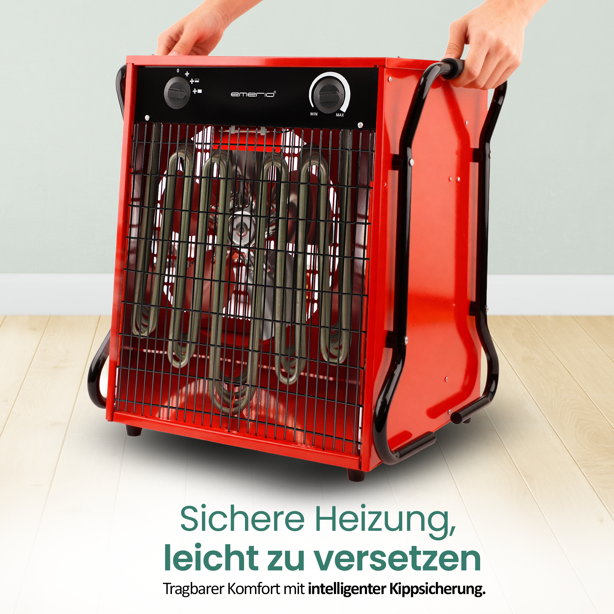 Ein roter Elektroheizer mit schwarzen Griffen wird von zwei Händen gehalten. Der Heizer hat ein Metallgitter und Heizelemente.