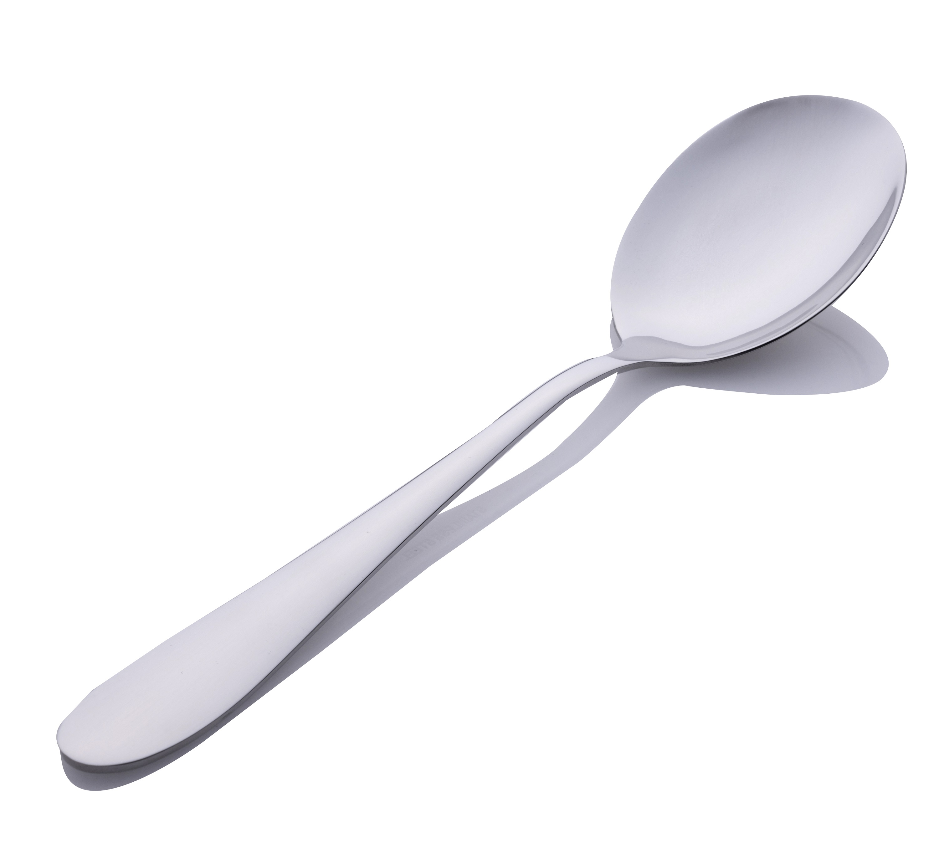 A shiny silver spoon is on a white surface, casting a shadow. The spoon is slightly angled.