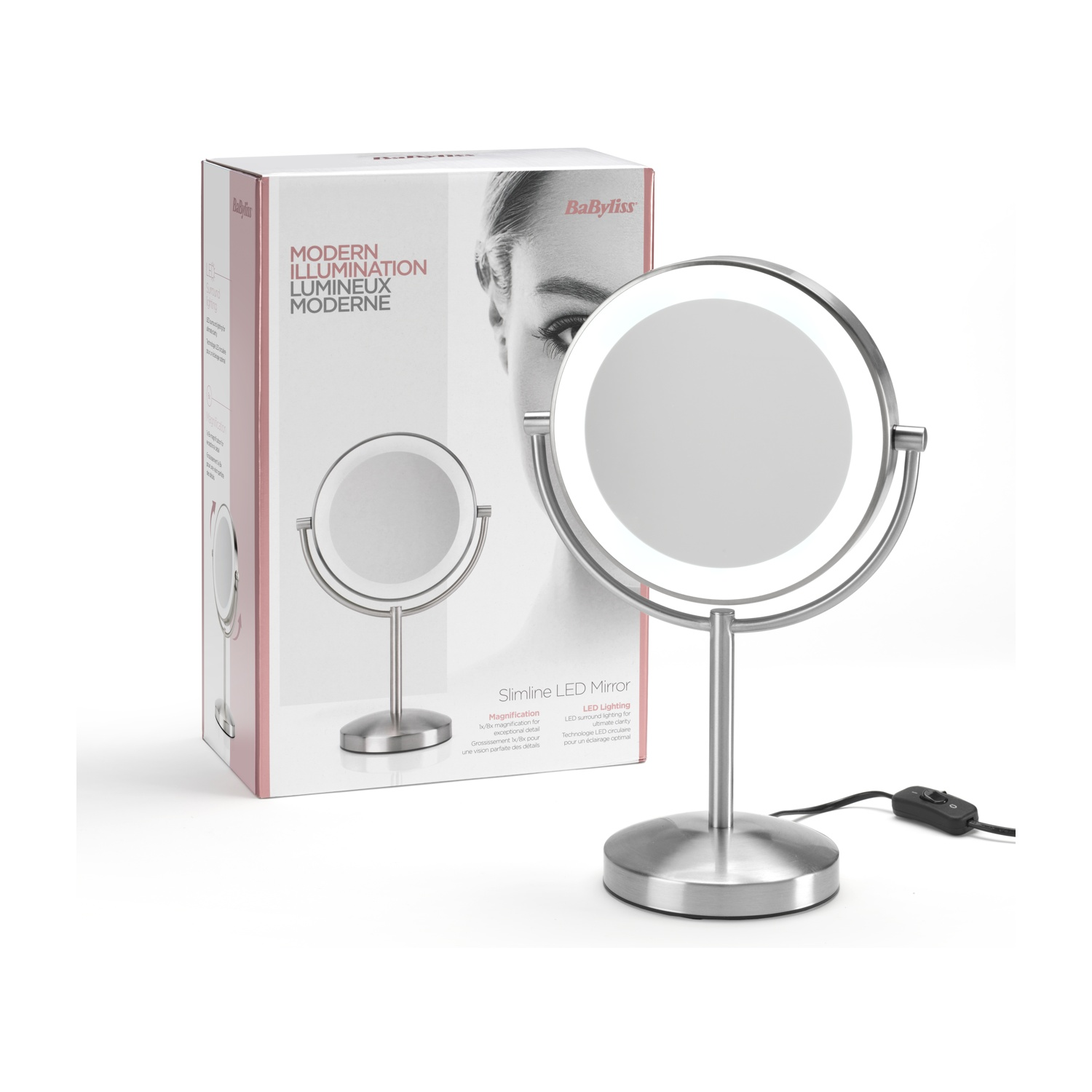 Ein beleuchteter, silberner Babyliss Slimline LED-Spiegel steht neben seiner Box, beides auf einer weißen Oberfläche. Die Box hat Text in mehreren Sprachen.